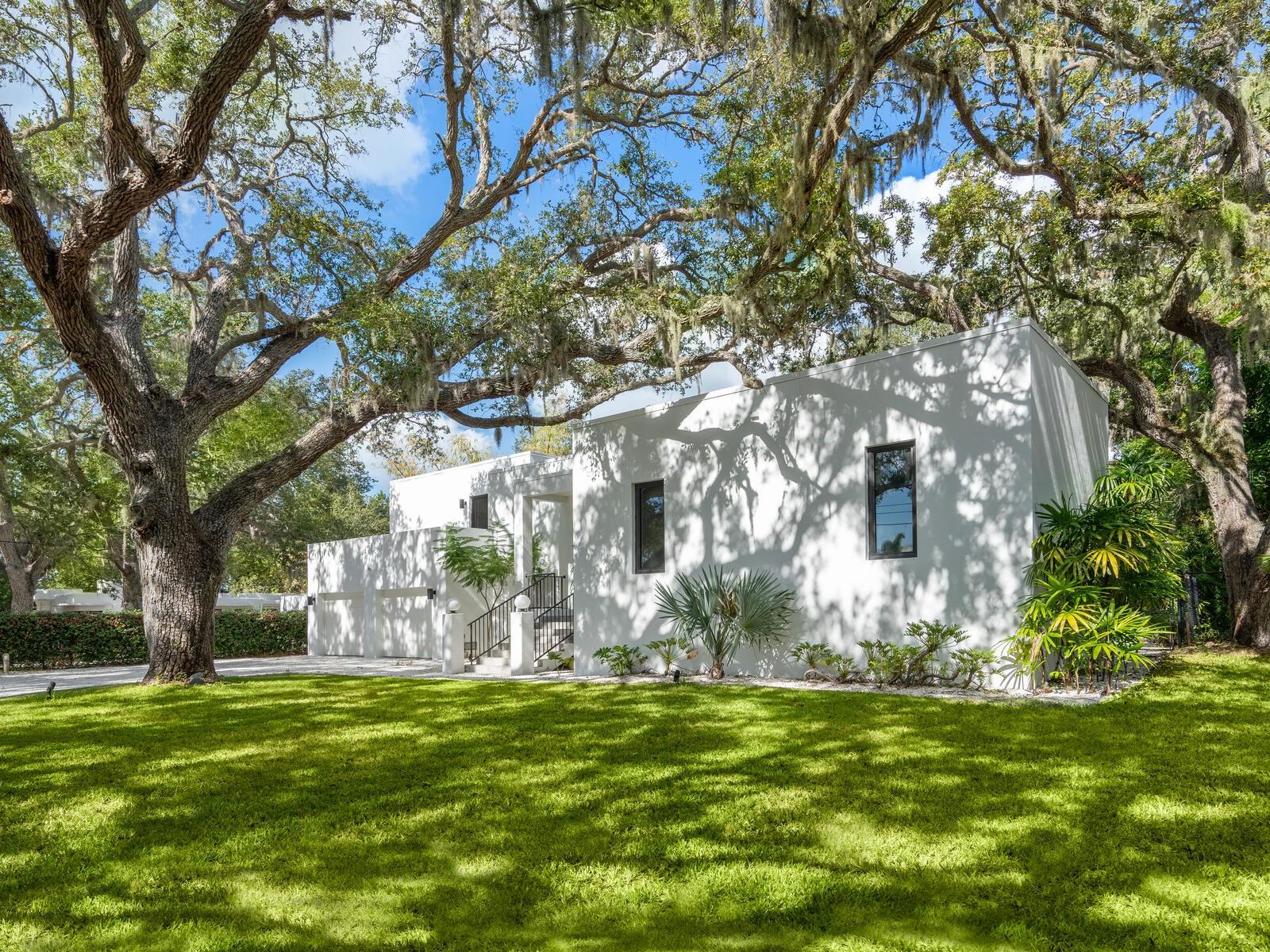 Villa Coquina is a luxurious, modern residence in the exclusive Oyster Bay neighborhood. Built in 2006 by architect Jack Jetton, one of the original members of the Sarasota School of Architecture, it blends the iconic Sarasota School style with modern construction, featuring steel reinforced concrete walls, hurricane impact windows, and a raised/ventilated foundation. The fenced and gated property spans almost half an acre and includes tropical landscaping, ancient live oaks, and a heated salt-water pool creating your own private tropical modern resort.
This home offers nearly 3,400 sq ft of space, including 2,400 sq feet of interior space, with 3 bedrooms, 3 bathrooms, and an open floor plan designed to bring the outdoors in, with 12’ ceilings and walls of glass. The home was fully renovated in 2023 by architect Daniel Lear, with updates to electrical, plumbing, HVAC, cabinetry, counters, roof, and the addition of a third bedroom and bathroom. Interiors by designer Blair Moritz feature high-end finishes like Water Works plumbing, Bertazzoni appliances, Italian travertine counters, Reform European Cabinetry, and vintage lighting. Every single detail was completed with the highest quality craftsmanship, perhaps especially the original seashell concrete floors which were lovingly restored to enhance the properties midcentury modern roots.
The property also allows for future expansion, including the potential for a third-story ocean-view deck already engineered into the 2nd story. Villa Coquina offers a rare combination of modern luxury, climate proof construction, architectural history, and a prime Sarasota location near shopping, schools, beaches, and nightlife.