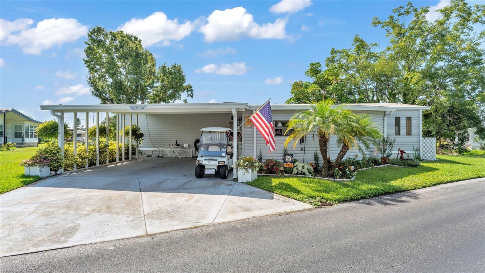 IMMACULATE WATERFRONT HOME IN FLORAL LAKES – Make every moment count, and enjoy the Florida lifestyle at it’s best in this beautiful 2 bedroom, 2 bath lakefront home. The contemporary design, and pride of ownership will impress you, as you step inside this lovely updated home. A well crafted custom wall bench welcomes you in through the entryway to the well equipped and graciously updated kitchen, offering an expansive center island with raised panel cabinetry with hideaway drawers and plenty of storage features. Stainless appliances, bead board backsplash and updated lighting complete this modern style with calming views of lake at the lookout window and breakfast nook...an ideal space for entertaining. Fabulous wall to wall built-in cabinetry offer functional custom features and a great focal point to the living and dining room space, with large windows to bring plenty of natural light into the heart of this home. The private primary bedroom is spacious and offers woodplank accent on the ceiling, sliding doors to the screened lanai overlooking the the lake, and an updated en suite bath featuring raised panel cabinetry with dual sinks, large tiled shower and walk-in closet. The guest bedroom includes a built-in desktop and is in close proximity to the updated guest bath, providing comfort and convenience for all. This home offers great versatility with an office overlooking the lake, and a flex space for crafts or extra interior storage space. Special highlights for this home include, spacious 1,464 sqft of living area, updated luxury vinyl plank and laminate flooring, new air conditioner in 2024, double pane windows, vaulted ceilings, ceiling fans, low maintenance vinyl siding on exterior, durable wood-alternative composite front stairs and deck, two car carport and golf cart garage with automatic door, featuring a workshop and laundry. This is a golf cart friendly community, and as a bonus, the golf cart is included! Outdoor entertaining is a breeze on the spacious screened lanai, or step down the wood deck to the open patio, all while enjoying serene views of Big Bass Bay and surrounded by vibrant colors and landscaping. Floral Lakes is an active 55+ community and provides many amenities, including a beautiful clubhouse, heated pool, billards, shuffle board, a putting green and garden areas for all residents to enjoy. Community fees include all amenities, social activities, exercise classes, games and more, plus optional camper/motor home storage for additonal fees. Conveniently located near shopping, restaurants, local eateries, and central to Tampa and Orlando for a quick commute to Florida attractions and beaches!
