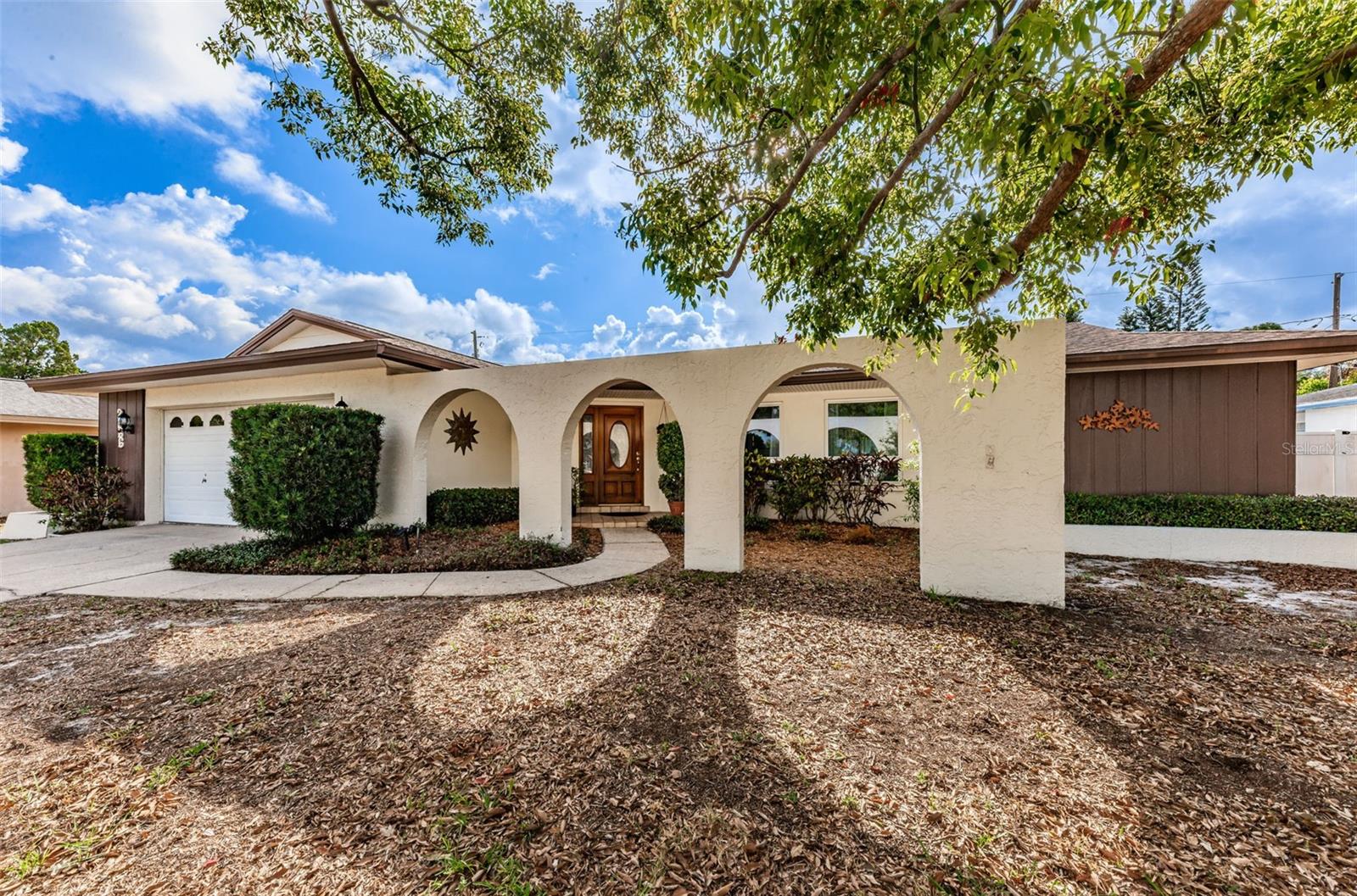 Welcome home to a wonderful, four bedroom home with a pool, in desirable Dunedin! Inviting arched entry with wood door leads to the tiled foyer which opens to a spacious, formal L-shaped living/dining room. The thoughtfully designed split bedroom plan features a primary bedroom complete with an ensuite bathroom featuring a shower, double sink vanity, and a convenient walk-in closet. The updated kitchen boasts beautiful wood cabinetry with GE appliances (including a French door refrigerator, glass top range, wall oven & microwave) and a breakfast bar! The family room is tiled and has a sliding glass door that opens to a beautiful, enclosed lanai and pool/patio area! Adjacent to the family room, you will find three generously sized bedrooms and a second bathroom featuring a tub/shower combination and a double sink vanity. For added convenience, an inside laundry room and an oversized two-car garage are at your disposal. Updates include a new HVAC system installed in March 2023 and a new water heater in December 2021. Doube pane impact windows, including attractive picture windows in the living room! Plantation shutters in all the bedrooms. 8' vinyl fence around the pool area creates total privacy! This home offers a desirable location within walking distance to shopping venues and a variety of restaurants. Additionally, it provides easy access to Countryside Mall and Mease Dunedin Hospital. Residents can take advantage of the amenities offered by the City of Dunedin, including a community pool, recreation center with a gym, and fitness center. For those with artistic interests, the nearby Dunedin Fine Arts Center offers a range of art programs for both adults and children throughout the year. The charming downtown area of Dunedin is home to delightful shops, restaurants, and a marina. Nature enthusiasts will appreciate the beautiful parks and beaches, such as Honeymoon Island State Park and The Pinellas Trail. Embrace the rich history and coastal charm of this wonderful town that you will be proud to call home.