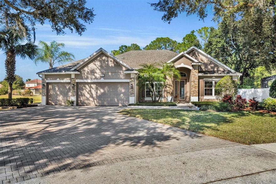 Welcome to the highly desirable community of Blue Lake Estates! This private, gated, all ages community has beautiful views of Blue Lake in Eustis. Come see this impeccable custom 3 bedroom, 3-bathroom home. No neighbors to the left due to a large detention pond/not retention pond.  There is a spacious bonus area that is being used as a gym, which can easily be converted to a 4th bedroom. There is also a dedicated office space.  Upon entering the home there is a spacious open floor plan with beautiful laminate and ceramic tile flooring and crown molding throughout. The family room includes a fireplace, designer niche shelves and a stone feature wall. The family room is open to the kitchen, dinette area and formal dining room. The family room, kitchen and dinette are open to a large, air-conditioned enclosed sunroom with a white vinyl fenced backyard view of pure tranquil privacy. The large dream kitchen has 42” cabinets, granite counter tops, double pantries, center island and built in desk plus a dinette area. Two sets of French doors lead into the sunroom from the kitchen. The primary suite is spacious and features a tray ceiling, French doors leading out to the sunroom and his/hers closets. The primary bath boasts a Jacuzzi soaking tub, walk in shower and his/hers sinks and vanities. You will appreciate the oversized 3 car garage. This home has been kept in pristine condition with all newer windows (2014), new roof in 2023, new interior paint, Trane AC unit w/ heat pump and air purifier (2015), blown in R 38 insulation (2015) hot water tank & disposal (2019), French doors with sidelights (2018) bathroom update (2018) Irrigation system (2019) This fabulous home is located within minutes of all your shopping needs, Publix, Lowes, Target / Walmart and Restaurants galore! It is a10 minute drive to the new 429 expressways, about 30 minutes to Orlando and a 5-minute drive into Historic Downtown Mount Dora.