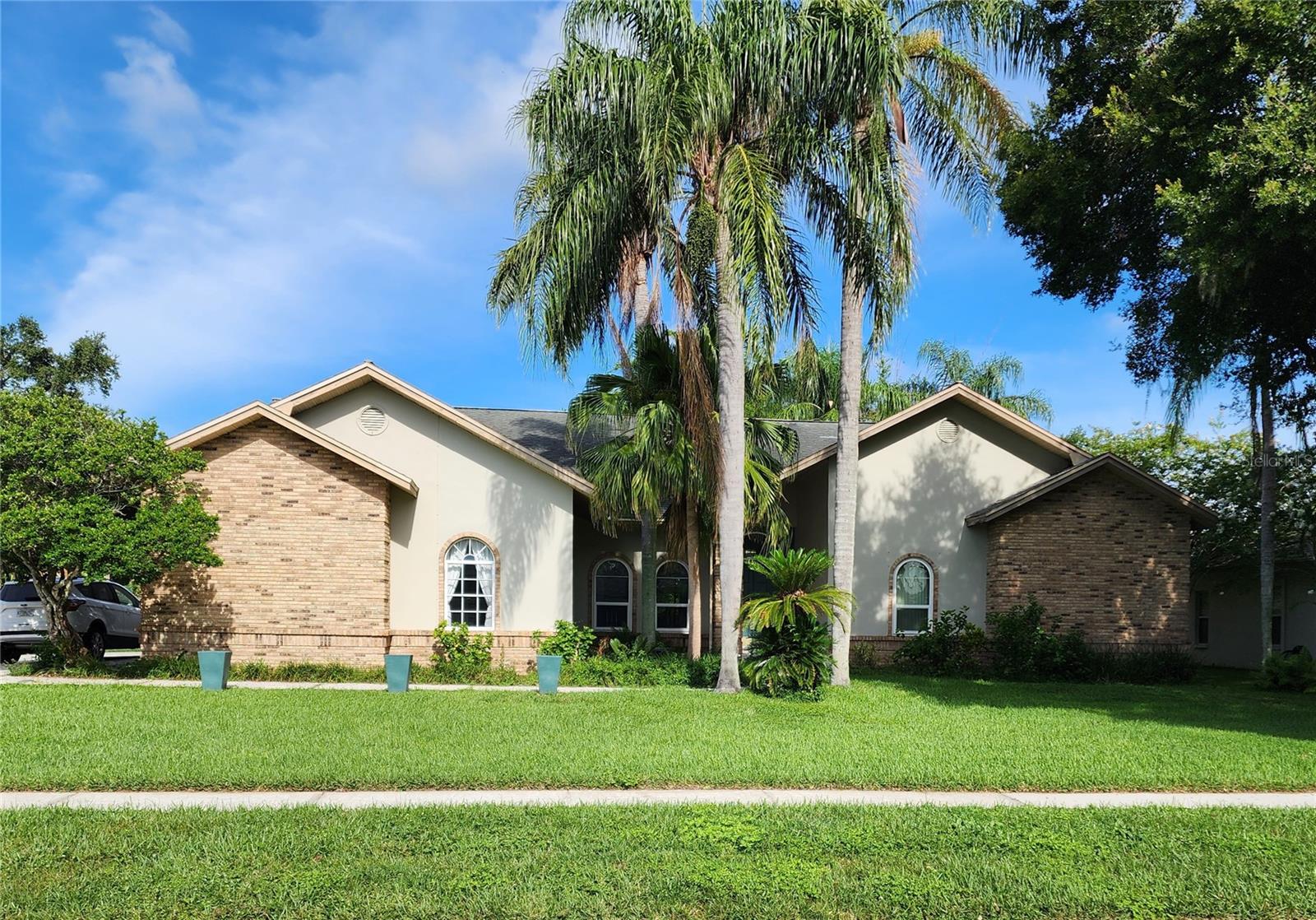 Welcome to this rare find in the highly sought-after, established community of Drakes Landing in the heart of Valrico, Florida. This unique four-bedroom, three-bathroom home offers both functionality and abundant space for entertaining. Its split floor plan also serves perfectly as a multi-generational living home. As you step inside, you'll be greeted by a large, open living room featuring sliding glass doors that lead to an oversized screened lanai. The perfectly sized dining room offers plenty of space for entertaining and flows seamlessly into the kitchen, which includes a built-in wet bar area and a charming breakfast nook. Overlooking the large great room is a stunning stone wood-burning fireplace, serving as the centerpiece. Adjacent to this area, you'll discover a separate bedroom and bathroom, ideal for a guest room or a multi-generational suite, perfect for today's lifestyles. On the opposite side of the home, you will find the primary suite, offering an abundance of space. The en-suite bathroom provides a large spa soaking tub, a separate walk-in shower, dual vanities, a private water closet, and a large walk-in closet—a true retreat. The additional bedrooms are nestled together and share a bathroom, providing ample space and privacy. As you step outside, the spacious yard is adorned with mature landscaping in a tranquil setting. Don't miss out on this rare opportunity to own this home in one of Valrico's best locations, close to shopping, restaurants, great schools, entertainment, and all major commuter routes. Schedule your private showing today.