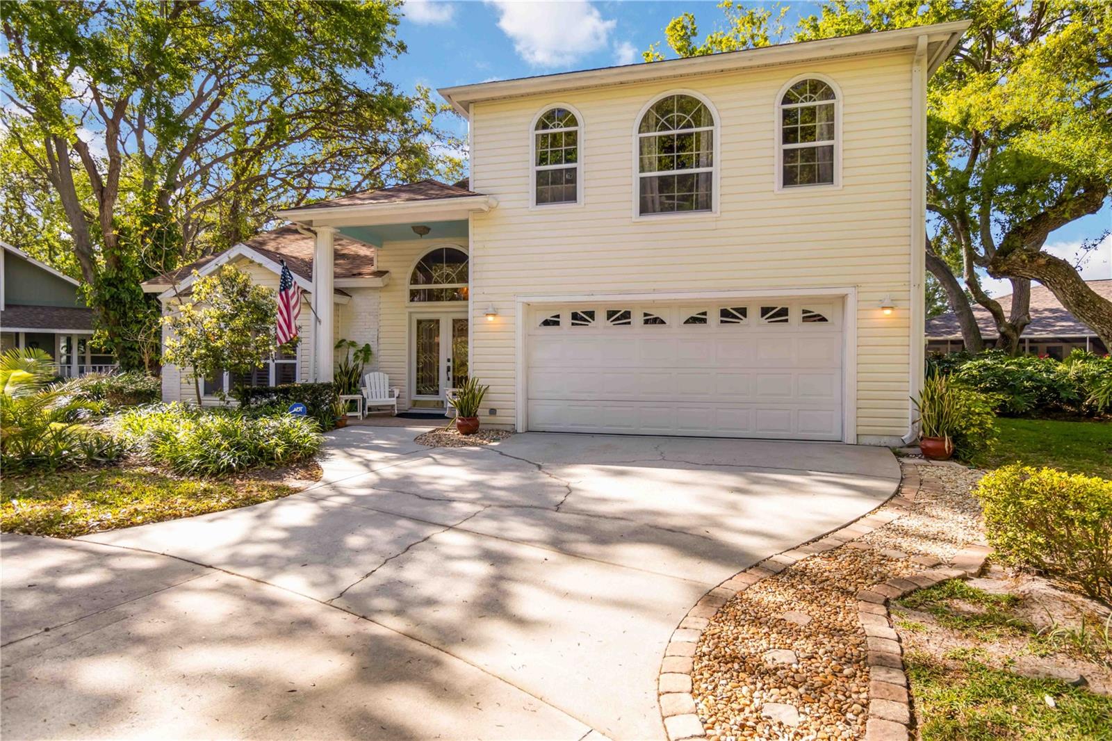 Welcome to this charming two-story home, offering over 3,000 square feet of beautifully designed living space in the quaint, tree-lined neighborhood of Arbor Oaks. Surrounded by majestic oak trees, and nestled in a cul-de-sac, this home provides a serene and picturesque setting while still being conveniently located near shopping, dining, and minutes from the stunning beaches of Anna Maria Island.
Inside, you'll find a spacious and inviting floor plan featuring real wood floors throughout the large living space. With soaring cathedral ceilings, you're instantly greeted with an open and airy ambiance that beautifully showcases this one of a kind floorplan. The large kitchen boasts ample cabinetry and large island which is perfect for cooking and entertaining. The primary suite located on the main floor is a true retreat with an ensuite bath and a large walk-in closet. Other charming features include a laundry chute, central vacuum, skylights and large radius windows letting in so much light. The loft space on the second floor adds additional flex space.
Enjoy relaxing evenings on the covered patio, overlooking the lush backyard shaded by beautiful oaks. Even more, the community pool is just steps away from your screened lanai, so you have the convenience of a private pool in your back yard but without the maintenance. With its charming curb appeal, ample space, and peaceful surroundings, this home is a rare find.