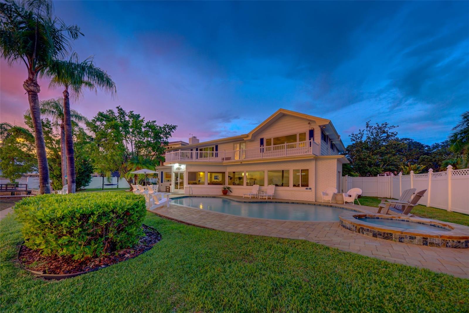 Welcome to your own piece of nautical paradise in Baywood Village! This stunning waterfront property sits on a lot and a half and offers an idyllic escape for water enthusiasts, located in close proximity to some of the most incredible fishing and diving spots in the region. Step into a world of relaxation and adventure as you make your way through the front door of this charming pool home. With spacious living areas and picturesque views of the water from nearly every window, you'll feel an immediate connection to the surrounding beauty of the intercoastal. This home is a 6 bedroom, 4 bathroom, pool home with spa, and a 2 car garage. NEW ROOF installed in 2021! The kitchen is outfitted with stainless steel appliances, commercial size refrigerator and freezer, quartz countertops, and custom cabinets. Investors will find this gem particularly appealing as a VRBO rental property with a proven track record of solid bookings and rave reviews. Guests can't resist the allure of this coastal retreat, leaving behind glowing testimonials of their memorable stays. In the evenings, gather on the patio or balcony to witness breathtaking sunsets casting hues of pink and gold over the water. The location of this waterfront haven is truly unbeatable.
