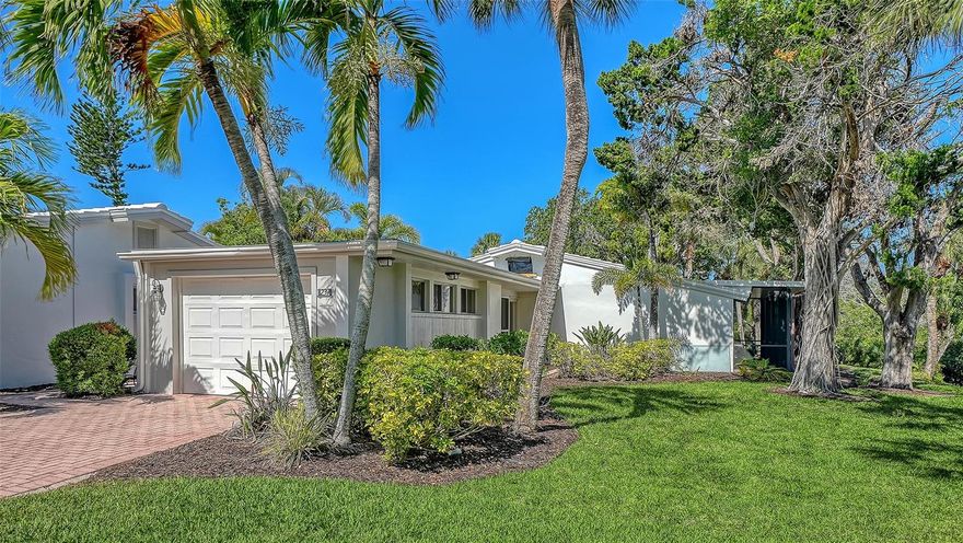 Tucked away in a peaceful, private setting overlooking the tranquil, shimmering lagoon - with its abundant fish, birds, and aquatic life - this beautifully updated 3 Bed/2 Bath villa in the premier GULF FRONT property of Whispering Sands offers the perfect blend of comfort, style and serenity. Step inside to discover a bright NEW kitchen featuring new granite countertops, stainless appliances, recessed & under cabinet lighting and an open, inviting feel ideal for everyday living and entertaining alike. Engineered wood flooring flows throughout the home, complemented by neutral paint tones, new interior doors, and thoughtfully updated baths with granite counters, new vanities and modern fixtures. A spacious screened brick paver lanai extending the full length of the residence may well be the star of the show, creating an ideal private indoor-outdoor living space to relax and enjoy the lush tropical surroundings. A private fenced brick paver patio offers an additional retreat for entertaining, dining al fresco, or simply unwinding in the Florida sunshine. Additional upgrades include a newly painted 1-car garage with new full-sized washer and dryer and new sink. The freshly painted front door, new screen door - along with a brick paver sidewalk and driveway - enhance the home’s welcoming curb appeal. Newly painted exterior in 2025. New landscaping is planned for the complex in 2026.  Whispering Sands is a 55+ Gulf front property offering 800’ of PRIVATE beach, 2 heated pools, beachside Tiki Hut and grills, shuffleboard, & canoe/kayak storage. The clubhouse is currently undergoing complete remodeling and will include fitness rooms, a full catering kitchen, large screen TV, and an elegant, comfortable space for social events. Ideally located just around the corner from the shops and restaurants of Siesta Key Village, this move-in ready property combines stylish updates, abundant outdoor living space, and a truly peaceful location to create the perfect coastal retreat!