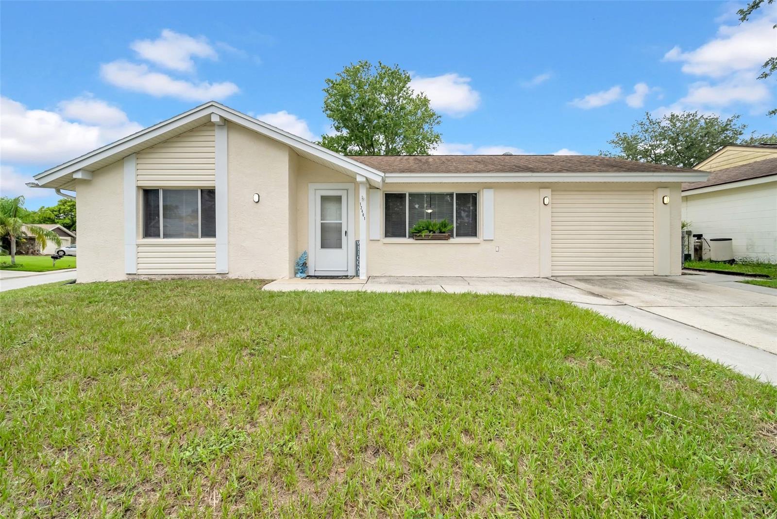 You have to come and see this one for yourself, priced to sell and so much space you will love this centrally located oasis on a large corner lot!! Brand new flooring in the bedrooms and bathroom and so much more! The open concept layout of this home makes it feel so spacious and open, you will feel it the minute you walk inside the door! When you stand in the kitchen you will know this is the place for you as you can see the entire home and outside all at once!! The garage was converted at some point in time into an extra-large bonus room so you can make this space suit your needs. When you go to walk outside you will be greeted with a very large screened in lanai and a fenced in yard. The pass-through window from the kitchen to the lanai makes it super easy and fun to entertain friends and family! This home is centrally located to everything you will need be it shopping, restaurants, medical, beaches, you name it you will find it so come and see this gorgeous home for youself, at this price it won't last long!