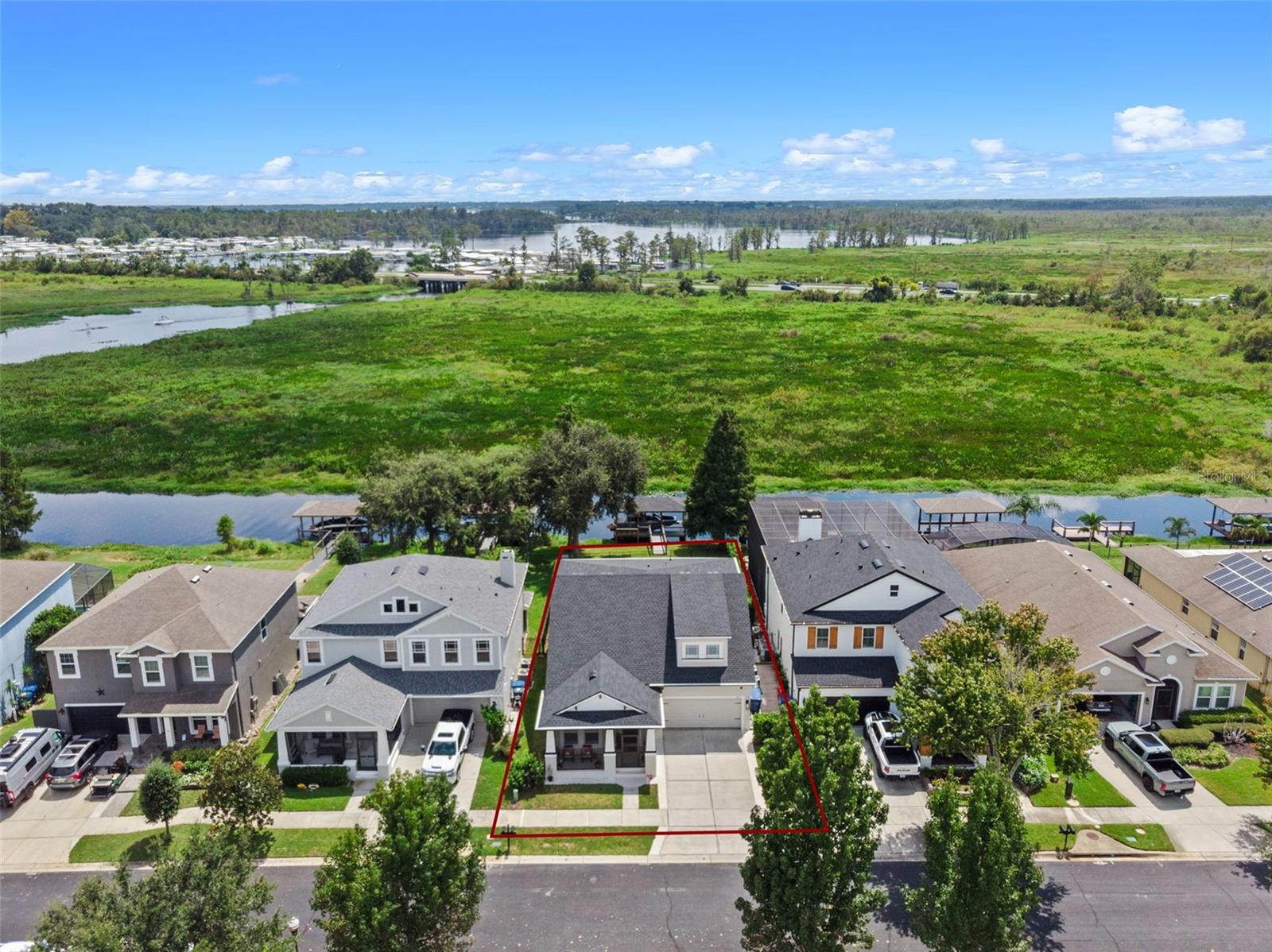 Experience lakeside luxury living on the highly sought-after Clermont Chain of Lakes! This stunning residence offers over 3,000 square feet of thoughtfully designed living space, featuring 4 spacious bedrooms, 3.5 bathrooms, and a true open-concept layout filled with natural light and modern upgrades. A brand-new 2023 boat dock with an aluminum lift is ready for your wakeboard boat—perfect for skiing, fishing, or cruising to one of the many lakeside restaurants. Inside, soaring ceilings, upgraded flooring, and expansive windows showcase breathtaking water and marsh views from all the main living areas. The chef’s kitchen is a dream, complete with stainless steel appliances, luxury countertops, abundant cabinetry, and a generous eat-in space. Flowing seamlessly into the oversized living room, this area is ideal for entertaining or simply unwinding with panoramic lake views. The formal dining room adds an elegant touch for special occasions. The main-level primary suite is a serene retreat, offering a spa-like ensuite with dual vanities, a walk-in shower, and a spacious walk-in closet. Upstairs, a versatile family room awaits—perfect for game nights or movie marathons—along with three additional bedrooms, two full bathrooms, and a dedicated office space. This home has been meticulously maintained and thoughtfully updated, including a new HVAC system (2021), a brand-new roof (2024), and numerous interior enhancements. Outdoors, the expansive backyard offers plenty of room for a future pool or can be enjoyed as-is with direct access to lakefront living. Waterside is a gated community equipped with resort style amenities. Residents enjoy a clubhouse, resort style pool, basketball court, soccer field, playground, park and much more! You're also nestled within a well-established community, this property enjoys an enviable location close to major highways, ensuring convenient access to all amenities. Just minutes away, residents can indulge in excellent shopping opportunities, dine at a variety of luxury and casual eateries, and explore nearby theme parks for entertainment. The neighborhood benefits from proximity to brand-new, state-of-the-art hospitals and a top notch school system, providing peace of mind for residents seeking quality healthcare services and high end education for their family. This vibrant community offers an abundance of options to suit every lifestyle need and preference. Call today to schedule a private tour.