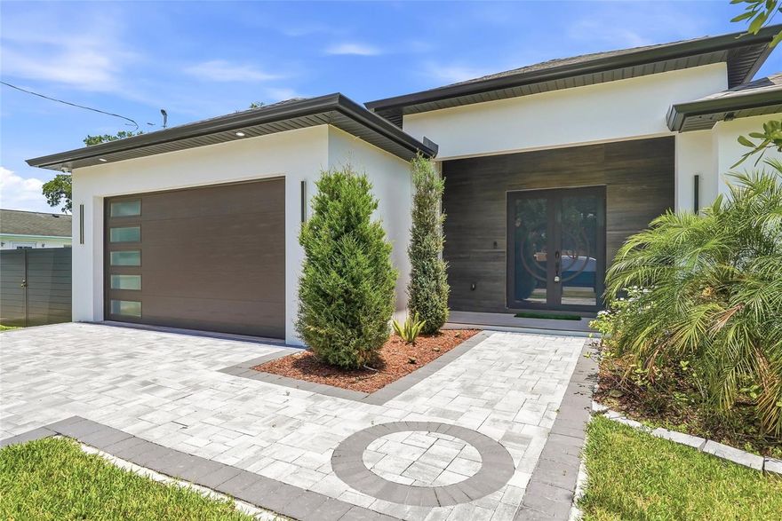 Experience elevated modern living in this stunning never-lived-in newer-construction residence offering 4 bedrooms, 3 bathrooms, and 2,464 square feet of thoughtfully designed living space in one of Tampa’s most convenient locations. Featuring striking contemporary architecture, clean lines, and upscale finishes throughout, this home perfectly blends style, efficiency, and functionality.

Inside, the open-concept layout is filled with natural light and enhanced by ceramic tile flooring throughout the entire home, creating a seamless modern feel with easy maintenance. The designer kitchen serves as the heart of the home, showcasing quartz countertops, sleek cabinetry, premium fixtures, and a large island overlooking the spacious living and dining areas — ideal for both entertaining and everyday living.

Built with spray foam insulation for enhanced energy efficiency and year-round comfort, this home was designed with both quality and performance in mind. Additional upgrades include a full camera security system, offering added convenience and peace of mind.

The spacious primary suite provides a spa-inspired retreat with a luxurious bathroom and generous closet space, while the additional bedrooms and full baths offer flexibility for guests, family, or a home office setup.

Step outside to enjoy the fully fenced backyard with ample room to create your ideal outdoor oasis. Conveniently located with quick access to Downtown Tampa, Tampa International Airport, Midtown, Raymond James Stadium, major highways, shopping, and dining, this exceptional property delivers modern luxury in a prime central Tampa location.