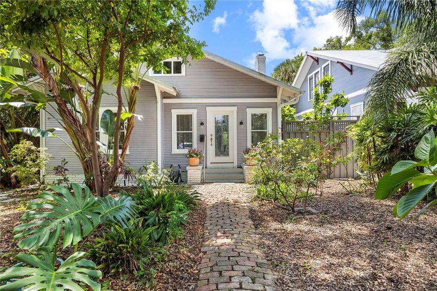 Welcome to one of Old Seminole Heights’ most charming pockets, located within a nationally recognized Historic District renowned for its collection of early 20th-century Craftsman bungalows, with this home standing as a shining example of the neighborhood’s timeless architectural character. This beautifully preserved and thoughtfully updated 1918 bungalow offers 3 bedrooms, 2 bathrooms, PLUS a detached 350 sq ft studio, seamlessly blending historic character with modern comfort. Inside, refinished original oak floors, a wood-burning fireplace, restored original windows, glass doorknobs, and classic Craftsman trim throughout fill the home with warmth, charm, and natural light. The beautifully updated kitchen features quartzite countertops and stainless steel appliances, while both bathrooms have been tastefully renovated, with all major updates completed in 2020. The primary suite showcases volume ceilings, dual closets with custom curtains, and a stunning clawfoot tub that pays homage to the home’s historic soul. A bright, airy palette throughout creates an inviting, move-in-ready feel from the moment you arrive. Major system upgrades and thoughtful improvements provide peace of mind, including a 2012 metal roof, tankless gas water heater (2020), updated interior plumbing, whole-house water softening system and reverse osmosis, full front and back irrigation, and a transferable termite warranty. The HVAC system features a 2020 exterior condenser and a 2012 interior air handler. Restored original windows and classic round dolly siding preserve the authentic character that makes Seminole Heights so sought after. Step outside to a fully fenced backyard retreat filled with Florida-friendly landscaping and an impressive collection of mature fruit trees and plants, including mango, avocado, banana, peach, plum, cherry, kumquat, and starfruit trees, along with a producing grape vine. A charming screened gazebo creates the perfect setting for morning coffee or evening unwinding. The renovated detached 350 sq ft studio features concrete floors, updated windows, its own wall-unit HVAC, and includes the washer and dryer, making it ideal as a home office, creative studio, fitness space, or guest retreat. A fully functioning pottery kiln located in the studio may also convey with the sale for buyers interested in ceramics or creative pursuits. And then there’s the location. Old Seminole Heights places you in the heart of one of Tampa’s most vibrant and walkable neighborhoods. Stroll to beloved craft breweries, neighborhood restaurants, and local coffee shops, or bike to the Riverwalk and Downtown Tampa in minutes. With quick access to I-275, commuting throughout the city is effortless. This is one of those rare neighborhoods where you can truly leave the car at home and enjoy the Tampa lifestyle to the fullest. Additional highlights include no HOA, no CDD, no flood insurance required as the home is located in Flood Zone X, no flooding or storm damage during the 2024 hurricanes, a brick-paved off-street parking area accommodating two vehicles, all appliances updated in 2020.