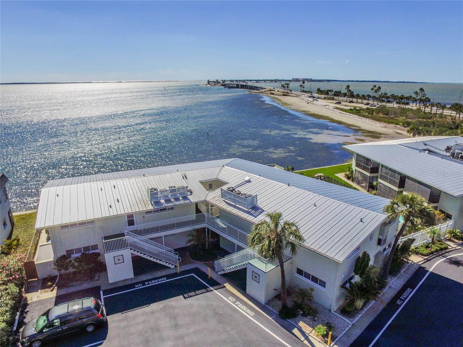 Concord Arms community in excellent Dunedin Causeway location. Studio unit with large screened lanai with pool and water view.