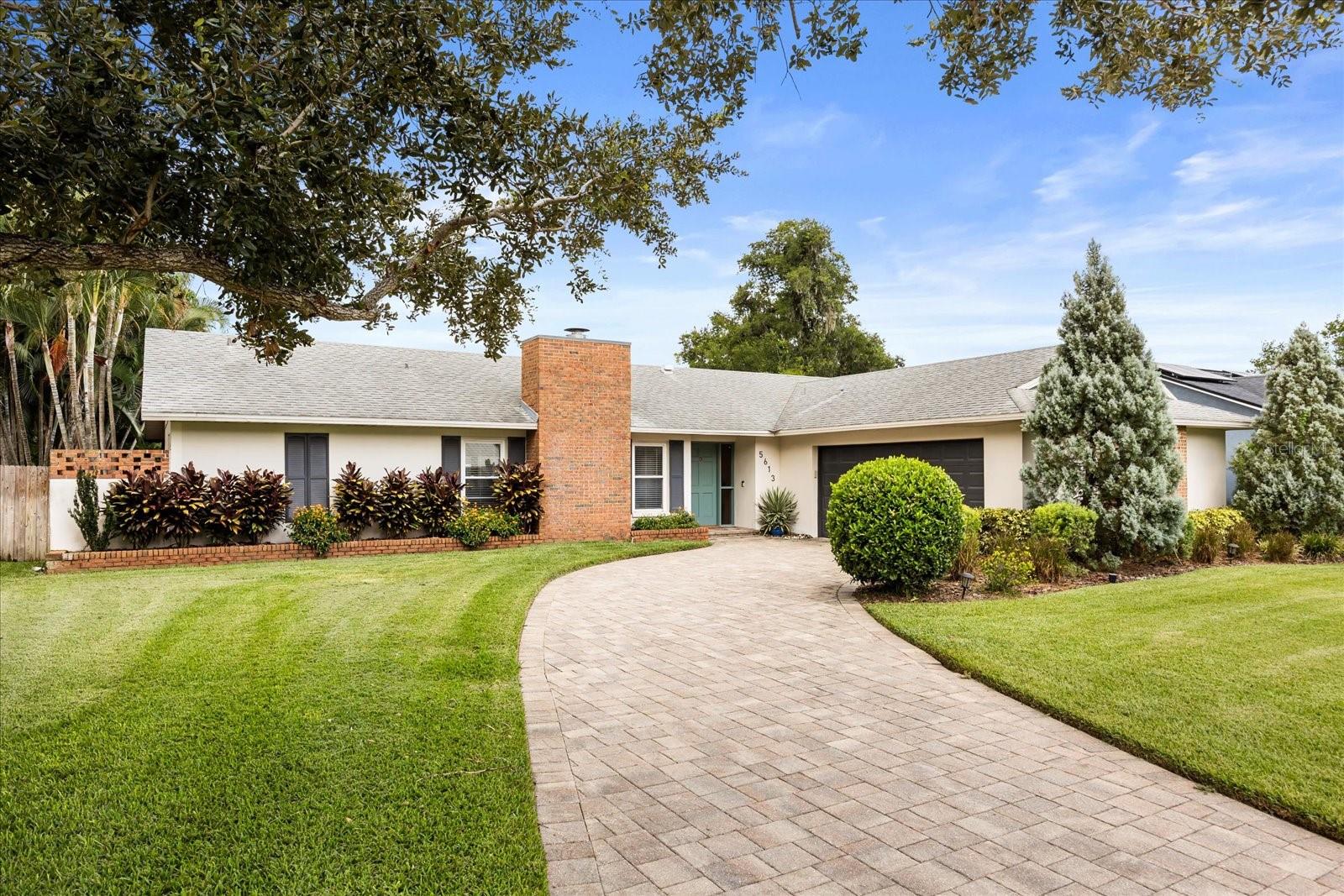 Welcome to Lake Mary Jess Shores – a charming lakefront community with lake access right down the street. This tucked away 29 home neighborhood is on a quiet, cul-de-sac street where mature oak trees create that quintessential Old Florida feel. Perfectly located just 5 miles from Downtown Orlando & the SR-408, 3 miles to I-4 Express Way, and minutes to the SR-528 & Sunrail, you’ll enjoy both tranquility and convenience.
Step inside to soaring vaulted wood-plank ceilings, gleaming wood floors, and a handsome brick fireplace that immediately set the tone for this stunning home. Freshly painted interiors and custom display shelving add a modern touch while enhancing the warm character of the open living and dining areas. The thoughtful split-bedroom floor plan places the spacious primary suite on one side, with two additional bedrooms on the other for comfort and privacy.
The kitchen is a chef’s delight, featuring light wood cabinetry, granite countertops, stainless steel appliances, and a large island that offers ample prep and serving space. Sliding glass doors from the kitchen, living room, and primary suite open to your very own outdoor retreat.
Outdoor living takes center stage here. A fully screened, brick-paver patio with a sparkling pool invites you to relax, entertain, and make memories year-round. Whether you’re grilling, enjoying a firepit, dining under cover, or lounging poolside, this backyard oasis has it all. Privacy screens, lush landscaping, and a fully fenced yard create the perfect private retreat.
The primary suite is generously sized to accommodate oversized furnishings and features a walk-in closet, dual vanities, and a large walk-in shower.
This home combines character, style, and modern updates—making it truly a showstopper, ready for you to move right in.