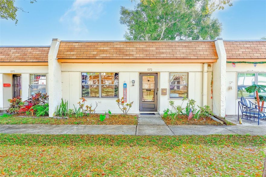 Welcome home to this beautifully maintained 2 bedroom, 2 bathroom villa with covered carport and additional storage, located in the 55+ Mission Hills community. The inviting kitchen features a newer refrigerator, gas range, and dishwasher, along with ample cabinetry and counter space. This home offers a spacious living and dining area, full-size washer and dryer, newer HVAC system, and updated wood-plank and vinyl flooring throughout. The primary suite includes generous closet space and a walk-in shower, while the second bedroom and neutral guest bathroom provide comfortable accommodations for visitors. A versatile bonus room off the living area opens to a rear courtyard. The monthly fee includes cable, internet, natural gas, water, sewer, trash, roof, exterior and grounds maintenance, use of community amenities, and land lease. Mission Hills is an active, well-maintained community offering a clubhouse with social room, library, fitness area, billiards, ping pong, shuffleboard, and a large heated community pool. Ideally located in Clearwater, just minutes from shopping, dining, grocery stores, hospitals, airports, entertainment, and the charming downtown areas of Safety Harbor and Dunedin, with easy access to the Gulf beaches.