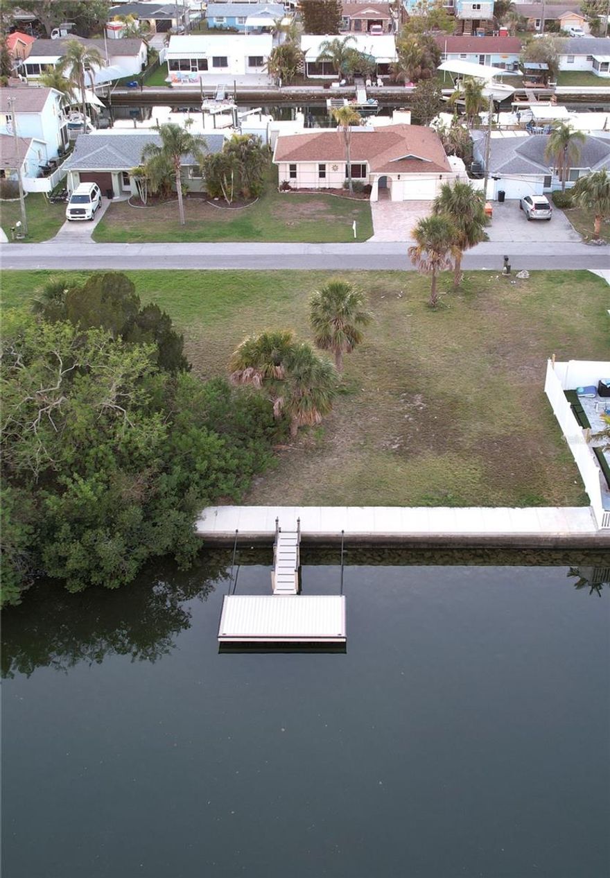 A true boaters dream! Stop dreaming and start building your dream waterfront estate on this prime deep saltwater canal lot only 5 streets in from open Gulf offering direct, no-bridge access to the Gulf of America! This cleared, high-and-dry parcel features 60 ft of seawall, deep water, a brand-new composite 8 x 16 floating dock (built by the most sought-after dock builder in the area) and a brand new beautiful 6 foot wide seawall cap. Survey, soil testing (Geotechnical Exploration) and drainage plans have already been completed! (All reports provided). Located in desirable Hudson Beach Estates, a premier non-HOA community, right around the corner from the beach, golf cart friendly neighborhood with dining and live entertainment all within reach by cart. This property is the perfect canvas to build your own custom retreat so you can enjoy your very own paradise!! DON'T MISS OUT ON THIS ONE!