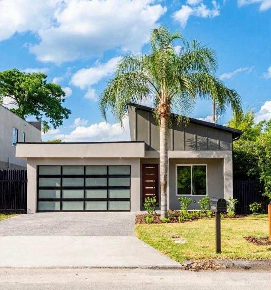 Modern Luxury Meets Everyday Comfort in the Heart of the Hourglass District
Welcome to this stunning modern build by Hourglass Homes — a bright and stylish retreat in one of Orlando’s most vibrant neighborhoods. Bathed in natural light from its dramatic roofline of windows, this nearly new home showcases thoughtful design and high-end finishes throughout. From the moment you step onto the wood-accented front porch, you’ll feel the care and craftsmanship that define this exceptional property.
Inside, the flexible 4-bedroom layout offers space to live, work, and relax — including a custom built-in bookshelf and cabinetry in one of the bedrooms, perfect for a home office or cozy retreat. All walk-in closets feature custom-built shelving for seamless organization, while LED cabinet lighting adds warmth and ambiance to the kitchen and bathrooms. The chef’s kitchen stuns with stainless steel appliances, quartz countertops, and designer finishes — a true centerpiece of the home.
The primary suite is a spa-like escape with dual rain showers, Bluetooth-enabled exhaust fans, and elevated quartz vanities. Additional perks include high-efficiency AC, spray foam insulation, LED lighting throughout, and no HOA.
Car lovers will be thrilled by the enthusiast’s garage, complete with SwissTrax flooring, a workbench, EV plug-in, and sleek honeycomb lighting for both function and flair.
Enjoy outdoor living on the screened-in back patio, accented with wood flooring panels, perfect for Florida evenings.
This lovingly maintained home is move-in ready and
waiting for its next chapter. Whether you're entertaining, unwinding, or simply living in style, this home delivers it all — comfort, efficiency, and location. Just minutes from local shops, cafes, and downtown Orlando, convenience meets charm in the sought-after Hourglass District.
Don't delay — call today!
