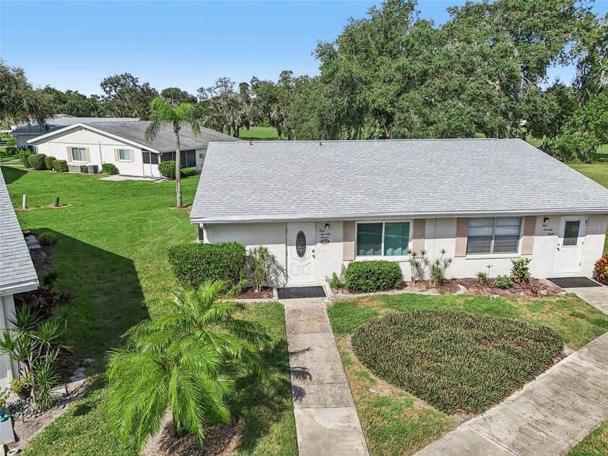 One or more photo(s) has been virtually staged. Photos don’t do justice to this one-story condo with a scenic view of a retired golf course that is now open space from the enclosed lanai. Many improvements have been recently made including the following: The kitchen was fully remodeled 2022 with all new appliances and hot water heater. The air conditioner was replaced 11/23/22 and an ultraviolet light which prevents mold growth was installed 4/16/25. The owner has a Kings Point Warranty Platinum level and just had an A/C check on 4/10/25. The entire home has tile except for the kitchen which has vinyl. One bedroom has custom closet organizer/shelving, and the other bedroom has a walk-in closet. This home has PGT 5500 series vinyl laminated insulated impact windows with cardinal 366 Low E - 2023 at a cost of $6,205.25 (except window to lanai and lanai windows). The lanai has double doors so that you can drive the golf cart in when you go away and it has and electric outlet for charging. There is close access to the walking/biking/golf cart trail on the retired golf course. There is a detached carport and guest parking. You’ll love the gated community of Kings Point, which has amazing facilities, pools, clubs and events just waiting for you to enjoy. Located between Sarasota and Tampa, this home is perfectly positioned for a convenient ride to airports, great shopping, dining, and professional entertainment. With easy access to award-winning, sandy beaches, you’ll experience the best of all worlds—without the stress of big city life. Leave the hustle behind and embrace a new chapter in Sun City Center, Florida, the state's top-ranked and most affordable 55+ retirement community. You’ll love this location on a less traveled, dead end street.