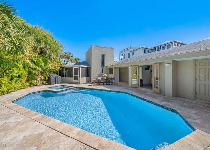 SIGNIFICANT PRICE IMPROVEMENT:  Easy Living in this single story Island classic designed by iconic Anna Maria architect H. Patterson Fletcher, who studied at Frank Lloyd Wright’s Taliesin.  He has incorporated many of his signature elements into the design for the home, including indirect lighting and aquarium style windows.  The current owner added roof mounted solar panels and supplemental solar hot water provide substantial utility savings. 

As you enter the property you are greeted by a large pool and spa surrounded by a spacious travertine tile patio.  Mature landscaping provides enhanced privacy and a welcoming outdoor environment, and a conveniently located  garage area provides room to store bikes as well as pool and beach gear.  

The central area of the home contains 2 Bedrooms and 3 full Bathrooms, along with an additional smaller room that is well suited as a study or children’s room, with enough space for a twin or trundle bed.  A delightfully private third bedroom and bath opens directly onto the pool through French doors and is accessible separately from the main house.  A huge living/dining area is graced by a working fireplace enhanced with coral stone, and a second living room overlooks your private dock and water view.  A screened patio area provides additional space for secluded dining and lounging. 

 

Enjoy an elegant yet laid back Island lifestyle in this unique home, hidden away on desirable Willow Ave on the North end of Anna Maria Island and located on Sailboat water, with direct access to Tampa Bay and Gulf waters.  Enjoy your coffee and serene sunrises on dock, in the company jumping fish and the occasional visiting heron.  Then, the hit the pool for a lively or laid back afternoon.  In the evening stroll directly to the Gulf beach to watch awe inspiring sunsets.  Enjoy this home as your private family retreat and also benefit from an impressive vacation rental income. VIEW 3D MATTERPORT TOUR.