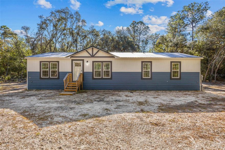 Move right in and enjoy the new home smell of this immaculate 2024 manufactured home on 2 acres (two attached lots sold as one) in Keystone Heights! This 1,560 sq ft, 3-bed, 2.5-bath home boasts high ceilings, beautiful vinyl flooring throughout, and a highly functional split bedroom plan featuring a welcoming great room at its heart. Culinary dreams come alive in the island kitchen, equipped with stainless steel appliances, including a huge side-by-side refrigerator. The primary suite is a true retreat, privately situated off the living room and offering a deep walk-in closet, plus an ensuite bath with double sinks, a relaxing bathtub, and a separate glass-enclosed walk-in shower. The two guest bedrooms share a convenient Jack and Jill bathroom with double sinks and a tub/shower combination, while additional storage includes a walk-in storage closet concealed by a distinctive barn door. Beyond the guest rooms are a back door, half bath, and laundry room outfitted with a washer and dryer. The expansive lot is already perimeter fenced, offering immediate privacy and security for family and pets. This generous space provides tremendous outdoor flexibility for various activities, future additions like a carport, workshop or pool, and currently features ready-to-use raised garden beds perfect for the home gardener. The laidback lifestyle of Keystone Heights offers the perfect blend of country charm and convenient recreation. You’ll be just 3 miles from the crystal-clear shores of Lake Geneva, offering endless opportunities for swimming, boating, and enjoying the outdoors. For even more adventure, the trailhead to the 47-mile Palatka-to-Lake Butler State Trail, perfect for hiking and biking, is only minutes away. When you’re ready to explore town life, the charming historic town center is just 5 miles from your doorstep. Best of all, you’re ideally situated: enjoy a quick 25-mile drive to vibrant Gainesville or an easy 57-mile trip to historic St. Augustine. Make this desirable Florida lifestyle yours, and book your private showing now before it’s too late!