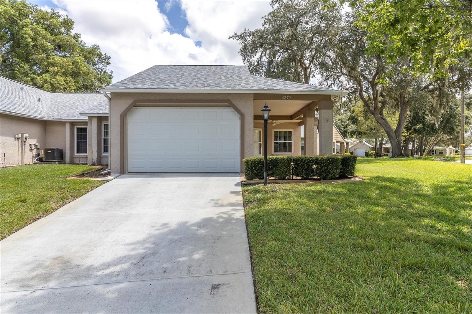 WELCOME HOME TO THIS 2/2/1 MINT CONDITION CONDO IDEALLY LOCATED IN ONE OF THE TRINITY AREAS MOST POPULAR AND AFFORDABLE OVER 55 COMMUNITY'S! YOU ARE GONNA' LOVE ALL THE EXTRAS AND UPGRADES INCLUDING NEW WINDOWS!!! CERAMIC FLOORING FLOWS THROUGHOUT THE OVERSIZED GREAT ROOM IT IS FLOODED WITH NATURAL LIGHT AND FEATURES ELEGANT CROWN MOLDING! THE KITCHEN HAS BEEN GIVEN NEW RAISED PANEL CABINETS AND STAINLESS APPLIANCES AND HAS A HANDY PANTRY! CONVENIENCE OF A DINETTE AND FORMAL DINING ROOM. THE PRIMARY BEDROOM IS A GENEROUS SIZE, HAS A WALK IN CLOSET & THE PRIVATE BATH HAS BEEN TOTALLAY AND ELEGANTLY UPDATED. THE GUEST BATH HAS ALSO BEEN BEAUTIFULLY UPDATED! THIS CORNER END UNIT FEAUTRES AN OVERSIZED GARAGE AND WIDE COVERED FRONT PORCH TO RELAX AND CATCH THE BREEZES! A SHORT STROLL DOWN WINDING TREE LINED STREETS DOTTED WITH SERENE PONDS TO THE ACTIVE CLUBHOUSE! IT FEATURES A HEATED POOL AND SPA, TENNIS CTS, BOCCE, PICKLEBALL, LIBRARY, CRAFT ROOM, EXERCISE CLASSES, POOL & BILLIARD ROOM, DANCES, PARTIES, AND MORE ACTIVITIES THAN YOU CAN KEEP UP WITH! ADD ALL THIS IN WITH THE AMENITIES THAT A TRINTY AREA LOCATION GIVES AND YOU HAVE AN AMAZING PACKAGE AT AN AMZING PRICE. HURRY TO THIS ONE! HESITATE...AND YOU'LL BE TOO LATE!