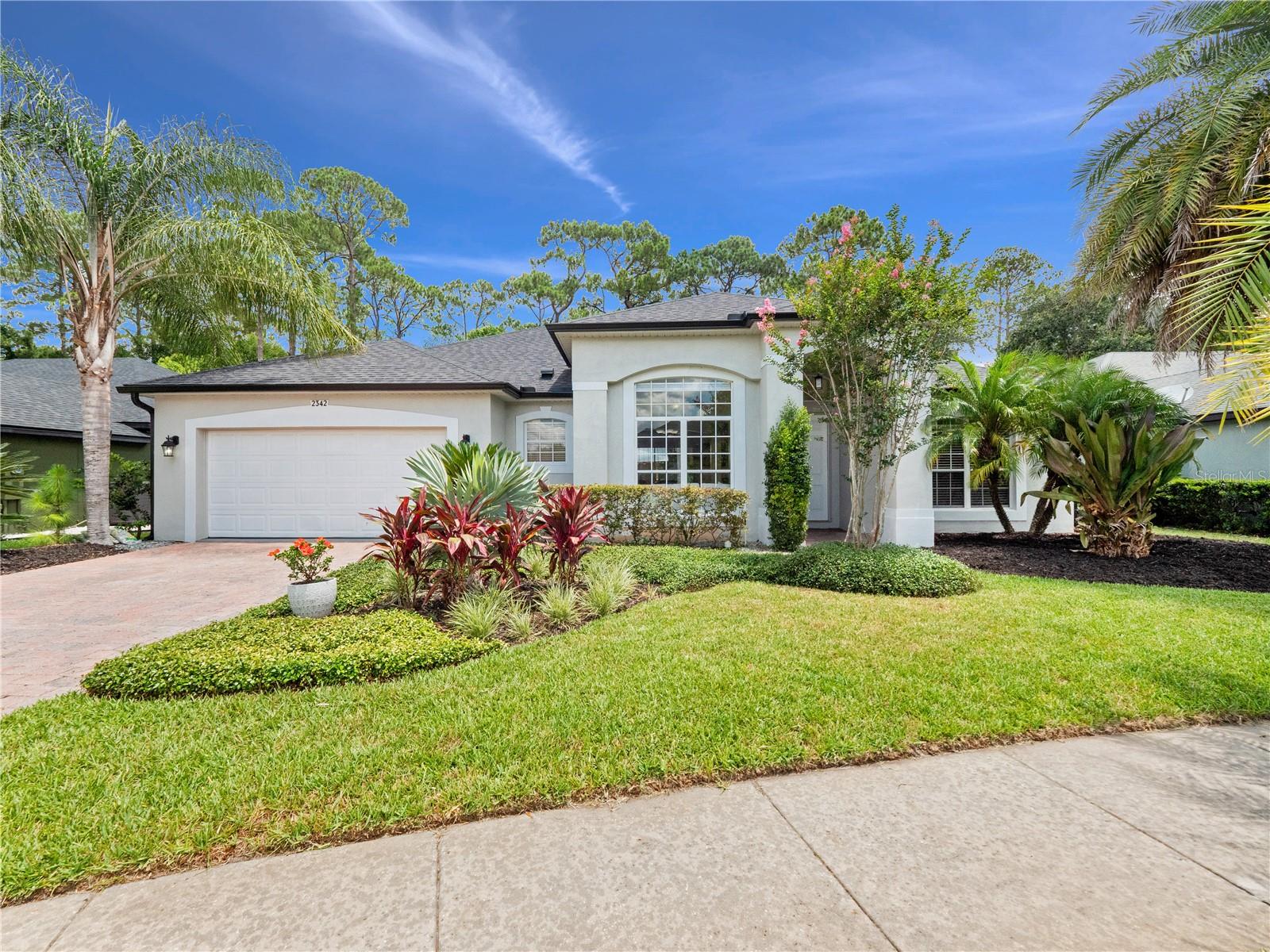 Welcome to 2342 Northumbria Drive located in the guard-gated community of Buckingham Estates! This beautifully maintained 3 bedroom, 2 bathroom home with a dedicated office is the perfect blend of style, comfort and Florida living. This single-story residence offers a desirable split floor plan with 12ft high ceilings, crown molding and elegant travertine flooring throughout the main living areas. The formal living and dining rooms create a welcoming flow into the open concept kitchen and family room perfect for entertaining. The kitchen features new stainless steel appliances, granite countertops and 42” custom cabinetry. The spacious primary suite features access to the lanai, dual closets with a walk-in closet, an en-suite bath with dual vanities, abundant counter space, a soaking garden tub, and a separate shower. Step outside to your own private tropical oasis featuring a resort-style pool and heated spa, custom tiki hut ideal for a bar and lounge area, fully fenced backyard, lush landscaping and plenty of privacy with no rear neighbors. Whether you’re entertaining or unwinding after a long day this outdoor space has it all. This home is move-in ready with a new roof, new HVAC, fresh interior and exterior paint, newer hot water tank and the list goes on. Located in one of the area’s most desirable gated neighborhoods, Buckingham Estates offers a community pool, clubhouse, playground and direct access to the Seminole Wekiva Trail. Zoned for top-rated schools and conveniently close to I-4, 417 and 429 and just minutes away from Lake Sylvan Park, Colonial Town Center, shopping and dining.Don’t miss this opportunity—schedule your private showing today!