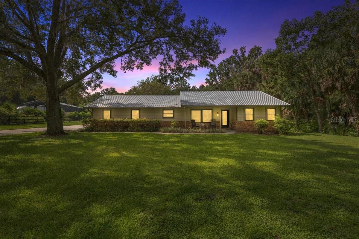 Beautiful 3BR/2BA Home on Nearly 1 Acre with Shop & Pole Barn!! Welcome to this well-maintained 3 bedroom, 2 bathroom home offering over 2,000 sq. ft. of living space on a .93-acre lot in a highly sought-after community. Inside, you’ll find a spacious kitchen with an abundance of cabinetry, granite countertops, and a formal dining room that could also serve as a home office. The oversized living room is perfect for gathering, featuring cathedral ceilings and a cozy wood-burning fireplace. The large master suite is a true retreat, complete with walk-in closets, plush carpet for comfort, and a beautifully updated bathroom with dual sinks, a vanity, and a walk-in shower with a built-in sitting bench. French doors open directly to the rear porch for private outdoor enjoyment. The two additional bedrooms each include walk-in closets and share a well-appointed full bath. Outdoor living is just as inviting with a large covered rear patio finished with pavers and a firepit—ideal for entertaining. The property also features a 24x24 prefab metal enclosed shop with two roll-down doors, plus a 24x28 open pole barn with a concrete base, perfect for boat or camper parking(installed in 2022). Metal Roof 2016 Windows 2024 Conveniently located less than 5 minutes from downtown Ocala where there are endless options for dining, shopping, medical offices and hospitals.