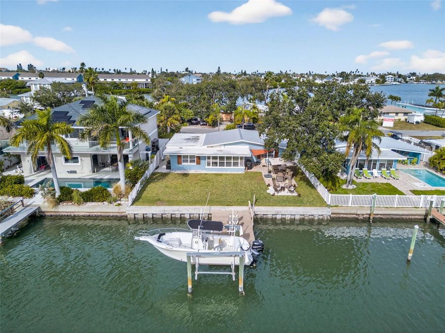 Your waterfront paradise awaits! Every day feels like vacation at 333 La Hacienda Drive, nestled in the heart of Indian Rocks Beach. This meticulously maintained 3-bedroom, 2-bathroom single-family residence offers an idyllic coastal lifestyle with breathtaking water views and is just steps from the beach.

Designed for both comfort and durability, exterior upgrades include a new 65-foot seawall (2021), whole-house hurricane shutters (2022), a resilient metal roof (2014), and underground cable and power. Boaters will appreciate the 7,000-pound boat lift and recently resurfaced private dock—perfect for embracing the waterfront lifestyle.

Inside, you’re welcomed by nearly 10-foot vaulted ceilings and an open, freshly painted airy living area featuring wood-look tile throughout and elegant plantation shutters. The gourmet kitchen is a true showstopper, complete with brand new stainless steel appliances and custom cabinetry, ample counter space, a built-in air fryer and convection microwave, and generous seating—ideal for entertaining or enjoying nights at home.

The one-car garage provides secure parking and additional storage for beach gear, bicycles, or a golf cart. Boater’s paradise and seaside sanctuary meet timeless elegance and modern design in this exceptional home.

Following Hurricane Helene, the home was fully and professionally remediated and thoughtfully remodeled, restoring it to exceptional condition with quality craftsmanship and attention to detail. Notably, the property had never experienced flooding or come close to flooding prior to this unprecedented storm, offering buyers peace of mind along with a beautifully refreshed living space.

Whether you’re seeking a full-time residence with stunning water views and beach access or an incredible opportunity to own a successful vacation rental, 333 La Hacienda Drive offers unmatched potential. Embrace the Florida lifestyle and make this beautifully restored waterfront retreat yours today.