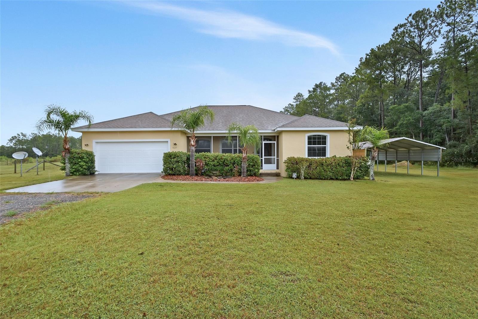 One or more photo(s) has been virtually staged. Beautiful 4BR 2BA home on 6.58 acres in the quiet country. 2 Car oversized Garage with pull down stairs to the attic. Enjoy the outdoors on the Huge deck with hot tub and lots of room for cookouts and entertaining. Zoned for agriculture with Fenced pasture, bring the horses, cows, etc. Lots of woods for exploring and room to have your own shooting range. Solar Panels and double pane windows make the home very energy efficient. Screen Front porch great for the cross breezes. Full home generator works with propane or gas. Great Room and Dining Room, Large breakfast/dinette area in kitchen. Maple kitchen cabinets. Primary bath has large soaking tub and walk in shower. Primary Bedroom has large walk in closet. 3 Extra bedrooms great for family or work from home office. No HOA, low cost road maintenance agreement with neighbors. No close neighbors, peace and tranquility on your piece of paradise. bring the 4 wheelers, enjoy lots of wildlife and nature. Horses, cows chickens ok. 2 Car Carport great for extra vehicles or place to keep your boat. Close to Hwy 40 easy commute to Ormond Beach 30 min or less. Ocala National Forest very close by. Only a few minutes to the St. Johns River in Astor for a day on the boat. Ready for a new family who wants to get back to nature.
