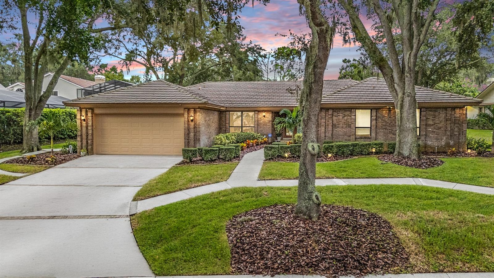 One or more photo(s) has been virtually staged. Imagine stepping out your front door to stunning views of Lake Tarpon—or enjoying the peaceful stillness of the water right from your dining room table. Welcome to this warm, inviting, and beautifully appointed custom-built Schaeffer home in the sought-after Sanctuary at Cobbs Landing. Located on a tree-lined street in one of Palm Harbor’s premier communities, this meticulously maintained 4-bedroom, 3.5-bathroom pool home offers a STUNNING Kitchen, and a spacious and versatile floor plan with open Den/Flex Space, that’s perfect for both everyday living and entertaining. From the moment you enter through the elegant double doors, you'll be greeted by a light-filled foyer that opens to the formal living and dining areas—ideal for hosting guests. Recent Upgrades include: New Hardwood Floors, New Flat Roof, New Electrical Panel, New Hot Water Heater, Pool Refinished, New Heater for Pool, New Interior Doors and Ceiling Fans, and much more! The chef-inspired kitchen is a standout feature, boasting stainless steel appliances, double oven, rich wood cabinetry, granite countertops, a large center island, breakfast bar, and more. Adjacent to the kitchen, the cozy family room features custom built-ins, a beverage fridge, wood-beamed ceilings, engineered hardwood floors, and a charming brick wood-burning fireplace—perfect for cool evenings. One of Schaeffer's signature touches is the use of floor-to-ceiling windows, flooding the home with natural light and showcasing breathtaking views throughout. Enjoy your morning coffee in the breakfast nook, overlooking the sparkling pool and spa. The primary suite is a true retreat with a walk-in closet and luxurious en suite bath featuring jacuzzi tub with decorative leaded glass window, step-in shower, and double vanity with stone counters. A second bedroom includes its own half bath and convenient access to the pool bath and sauna. Two additional bedrooms on the opposite side of the home share a beautifully updated full bath with granite finishes. Outside, you'll find your personal oasis: a screened, covered lanai, outdoor bar area, and large backyard ideal for gatherings, play, or relaxation. Take a dip in the sparkling resurfaced pool with spill-over spa, or just unwind and enjoy the peaceful surroundings. Living in Cobbs Landing offers an unbeatable lifestyle. Keep your boat close at the community marina with private boat slips, or launch it from the on-site boat ramp and explore all that 2,500-acre Lake Tarpon has to offer—from world-class bass fishing to wakeboarding and tubing. Plus, there's a community park and playground just steps away, featuring tennis and basketball courts with serene lake views. Zoned for the highly rated PALM HARBOR UNIVERSITY, this home is also just minutes from airports, beaches, top-rated restaurants, parks, the renowned Innisbrook Golf & Spa Resort, and the Pinellas Trail. Don't miss your chance to own a piece of paradise—schedule your private tour today!