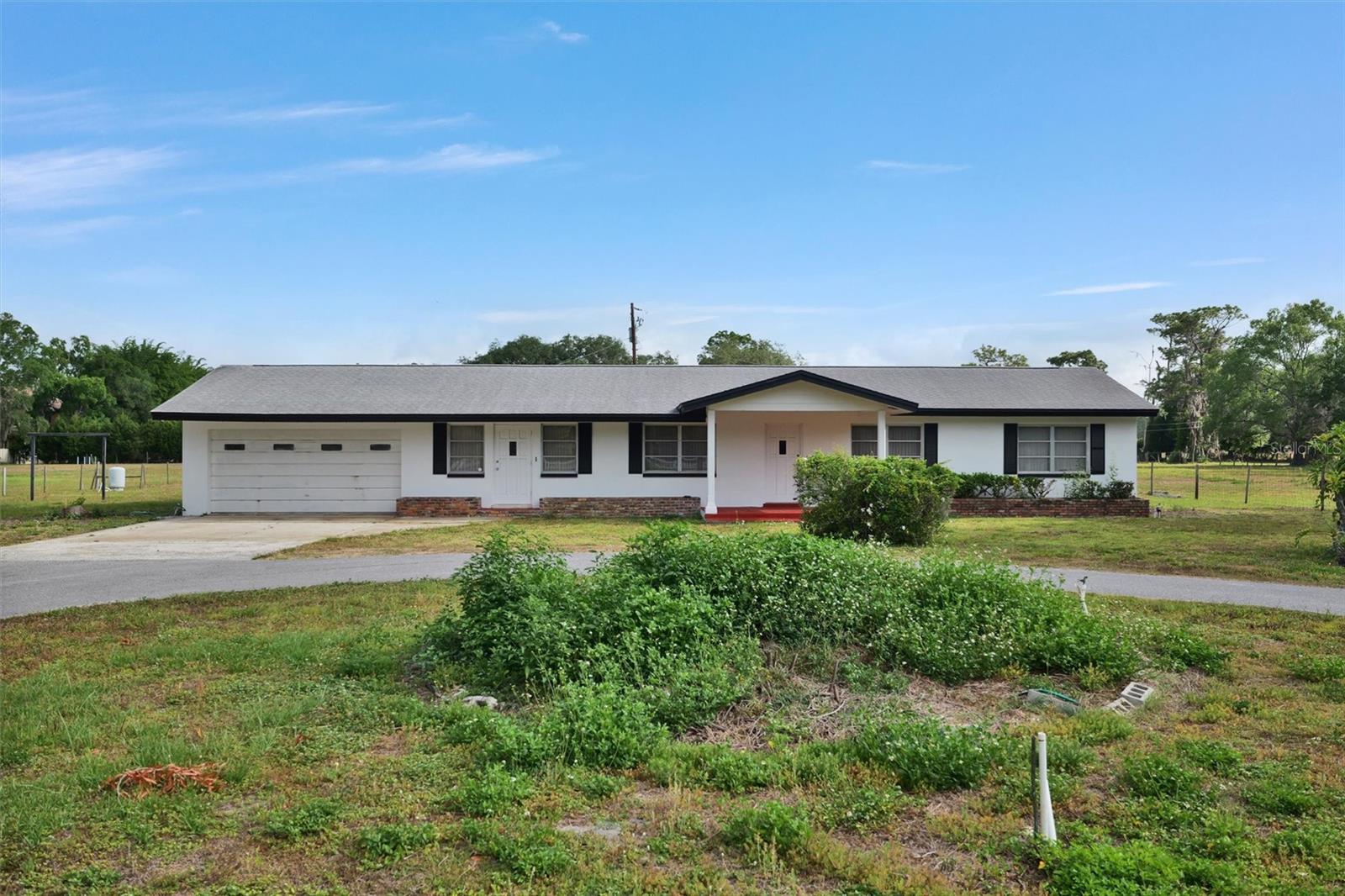 A great mixture of Country and Residential with a City in close proximity. Almost 5 Acres of land and up to 2 Horses and livestock that goes along with this 3-bedroom 2 bath Country ranch with a separate stable and storage garage. Immediate occupancy for this rural gem. There are a few horse trails a short distance at the end of Lora Lane and Old Keystone rd. The Pinellas Trail is across the street and the East Lake Sports complex is nearby. There is no carpet in the home and new laminate floors were installed in April 24. Move-in ready for a long-term rental agreement. 2 main airports are 25 minutes away. Excellent schools connected to this zip code and several golf courses nearby.