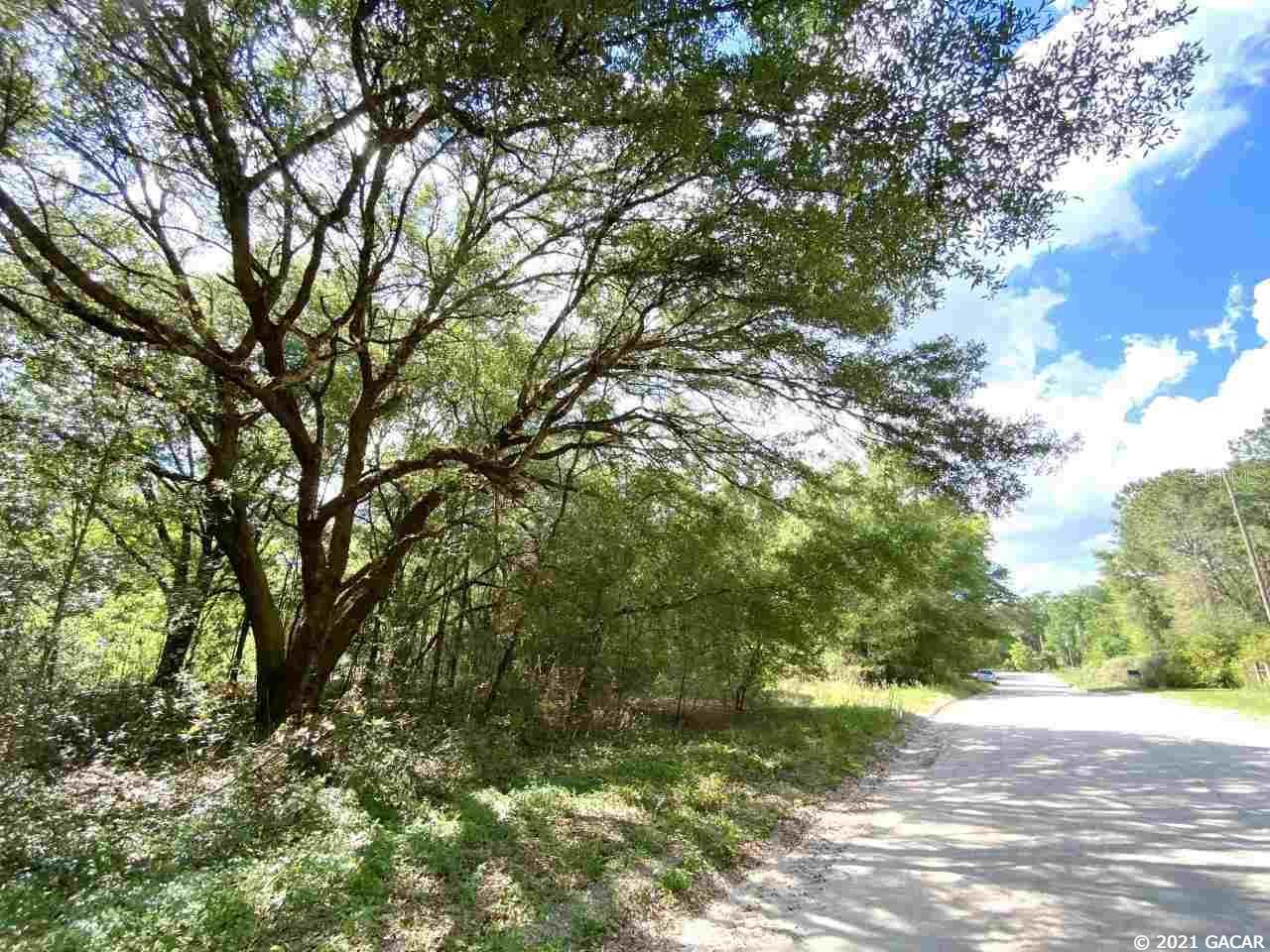 Beautiful 7 acre parcel located in Columbia County. Escape to nature on this peaceful wooded lot, with easy access to the amenities of High Springs or Lake City. Just a mile down a county maintained road, this property is mostly hardwoods, with a cleared drive that leads to a perfect location for a site built home or mobile. A small cypress pond on the rear corner of the parcel draws deer and turkey who bed nearby. Nature is waiting for you! Open Builder.