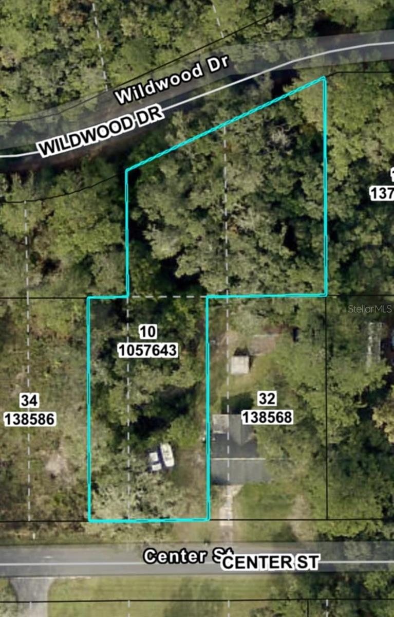 Prime vacant lot totaling 0.55 acres located in the desirable H & H Homesites community. This parcel offers excellent accessibility with approximately 138 feet of road frontage on Wildwood Drive and an additional 75 feet of frontage on Center Street. Partially fenced with chain link fencing and a double gate. Great for residential development or investment, the property provides convenient access from two paved roads and is situated in a quiet, established neighborhood.