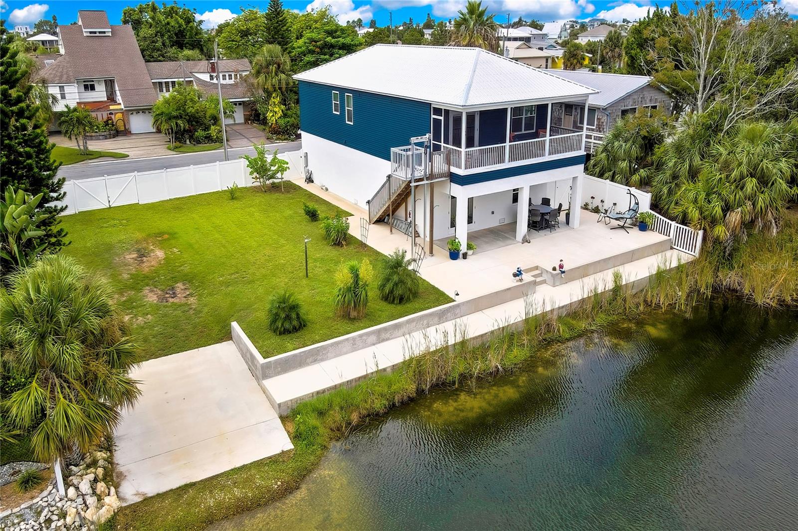 Beautiful elevated home built in 2023. Tranquil and private setting while being just minutes away from all of life’s conveniences, this waterfront home in Hernando Beach has it all.
OVERSIZED FENCED DOUBLE LOT, 18 Ft. BOAT RAMP, 80 Ft CONCRETE SEAWALL, GULF ACCESS, METAL SOUND PROOFED ROOF WITH EXTRA INSULATION, NO HOA, NO SHORT-TERM RENTAL RESTRICTIONS.
The owner built this home with meticulous attention to detail and the best quality of construction to produce a home with timeless quality. Very open floor plan, crown molding, oversized 6” baseboards, volume ceilings and abundant natural light with expansive panoramic outdoor views. French doors from the living area lead to the covered and screened balcony that spans the rear of the home and provides beautiful views of both sunrises and sunsets. OUTDOOR LIFT for seamless access to your stunning backyard from the main level and with the touch of a button bring groceries, luggage or heavy boxes from the car to the main level without ever having to lift them up a single step.
GOURMET KITCHEN is a chef’s dream with top of the line upgrades- QUARTZ COUNTER TOPS, BACKSPLASH AND ISLAND, SHAKER CABINETS, under the counter MICROWAVE with pull out drawer, PROPANE RANGE, COUNTRY FARMHOUSE SINK, RECESSED LIGHTING, LG APPLIANCES, Refrigerator with Double Ice Maker. Beautiful PLANK CERAMIC FLOORS throughout the entire home. Energy Efficient Home with DOUBLE PANE WINDOWS, ATTIC WITH THERMAL BARRIER INSULATION reducing HVAC wear and tear and providing very LOW ENERGY BILLS. Custom Lighting and upgraded Fans on all rooms, the QUARTZ continues in all bathrooms. Spacious master bedroom with extended walk-in closet. The master bath is a true spa-like retreat with sitting area, custom dual-sink vanity with stunning, low-maintenance quartz countertops and spacious walk-in shower with Trasom Window- showcasing custom-laid porcelain tile, grab bar and a removable handheld shower head. Entire ground floor is an oversized block garage (extended 5 feet) with room for 4 cars, a boat, toys and workshop. Walls are upgraded cement board and not drywall. Extra storage closet was added under the stairs. Behind the garage is an extended and covered lanai with a concrete slab that wraps around the side of the house and all the way to the seawall. If you are tired of the snow and cold winters do not miss this great opportunity and start enjoying the pleasures of the Florida Lifestyle. Conveniently located with easy access to beaches, natural parks, dining, entertainment and more! LENDER INCENTIVE/CONCESSION AVAILABLE FOR BUYERS. Call for details. VISIT OUR 3D TOUR.