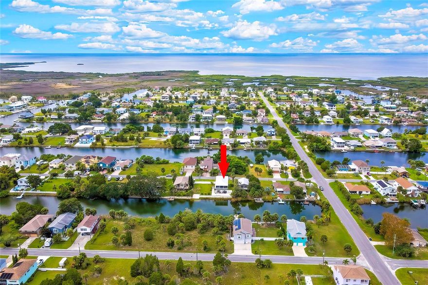 2023 ELEVATED WATERFRONT HOME • GULF ACCESS • DOUBLE LOT • NO HOA  •  Built in 2023 with exceptional craftsmanship and timeless quality, this elevated waterfront home in Hernando Beach delivers the Florida lifestyle buyers are actively searching for — privacy, quality construction, and Gulf access, all just minutes from everyday conveniences.
Set on an OVERSIZED, FULLY FENCED DOUBLE LOT, the property features an 18-FT BOAT RAMP, 80-FT CONCRETE SEAWALL, and GULF ACCESS, making it ideal for boating, fishing, and waterfront living at its best. With no HOA and no short-term rental restrictions, this home offers outstanding flexibility as a primary residence, second home, or income-producing investment.
Inside, the home showcases a bright, open floor plan highlighted by volume ceilings, crown molding, oversized 6” baseboards, and expansive windows that flood the space with natural light and panoramic outdoor views. French doors open from the living area to a covered and screened rear balcony spanning the width of the home, offering breathtaking views of both sunrises and sunsets over the water.
A rare and highly desirable feature, the OUTDOOR LIFT provides effortless access from the ground level to the main living area — perfect for groceries, luggage, or everyday convenience at the touch of a button.
The gourmet kitchen is a chef’s dream, featuring QUARTZ COUNTERTOPS, BACKSPLASH, AND ISLAND, SHAKER CABINETRY, FARMHOUSE SINK, PROPANE RANGE, UNDER-COUNTER MICROWAVE DRAWER, RECESSED LIGHTING, AND LG APPLIANCES, including a refrigerator with double ice maker. Plank ceramic flooring flows throughout the entire home, and custom lighting with upgraded ceiling fans adds style and comfort in every room.
The primary suite offers a spacious retreat with an extended walk-in closet and a spa-like bath featuring a sitting area, dual-sink quartz vanity, and a beautifully tiled walk-in shower with TRANSOM WINDOW, GRAB BAR, AND HANDHELD SHOWER.
Designed for efficiency and durability, the home includes DOUBLE-PANE WINDOWS, a METAL SOUND-PROOFED ROOF WITH EXTRA INSULATION, and an ATTIC THERMAL BARRIER, resulting in low energy bills and reduced HVAC wear.
The entire ground level is an OVERSIZED BLOCK GARAGE, extended 5 feet and offering space for UP TO 4+ CARS, a boat, workshop, and toys. Walls are upgraded CEMENT BOARD (not drywall), with added storage under the stairs. Behind the garage, an EXTENDED COVERED LANAI and WRAPAROUND CONCRETE SLAB lead all the way to the seawall — perfect for entertaining and waterfront enjoyment.
Conveniently located near beaches, natural parks, marinas, dining, and entertainment. If you’re ready to escape cold winters and embrace the Florida waterfront lifestyle, this exceptional home is a must-see.
Lender incentive/concession available for qualified buyers.
 Visit the 3D Tour and schedule your private showing today.