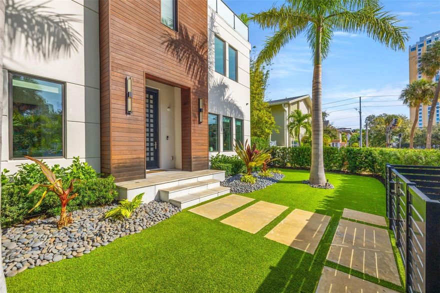 A dazzling masterpiece of engineering and design, this single-family home, completed in 2019, stands as the crown jewel of downtown St. Pete. Both smart and stylish, this spacious home features 6,617 SqFt of interior magnificence including 5 bedrooms, 7 bathrooms, a 328 bottle wine cellar, office, gym, bonus room & safe room, complemented by an additional 2,500 SqFt of rooftop terrace, presenting an unparalleled fusion of technology, style, & extravagance.

As you step through the oversized, custom Jeld-Wen Aurora front door, a world of sophistication unfolds. The clean & contemporary aesthetic of the hand-scraped wood floors, high ceilings, and exquisite finishes serves as a testament to the meticulous craftsmanship that went into this architectural marvel.

The kitchen is a culinary & entertaining paradise, featuring an ensemble of top-tier Sub Zero and Wolf appliances & an expansive island that serves as a beautiful focal point. The culinary arsenal includes a Wolf 6-burner gas range, oven, steamer/cooker & warming drawer, and a Sub Zero refrigerator/freezer that elevates storage to an art form. Delight in the convenience of Sub Zero refrigerator drawers discreetly tucked into the kitchen island, ensuring freshness at your fingertips. Porcelain Calcutta countertops & floor-to-ceiling soft-close cabinets, adorned with under-cabinet lighting, exude a modern elegance that seamlessly integrates form and function.

The retractable sliding floor-to-ceiling glass wall merges indoor & outdoor spaces, opening to a utopian oasis featuring a saltwater pool and spa, outdoor dining area, and putting greens.

Head on up to the rooftop terrace, a sublime sanctuary, that hosts a fire pit, putting green, indoor wet bar & spacious seating area, making it an enchanting spot to hang out and savor panoramic views of the cityscape.

The whole house is a tech enthusiast's dream, where cutting-edge innovation integrates into the fabric of daily living. The home is powered by a CONTROL4 full house automation system, orchestrating audio, TVs, select lighting, front door camera/doorbell, and security cameras at the touch of your fingertips. Three CONTROL4 touchscreens & remote access ensure effortless control over every facet of this smart ecosystem.

The perimeter is guarded by 12 exterior Hikvision HD dome cameras & 1 garage camera, all feeding into a 4TB camera system hard drive for seamless playback and storage. Immerse yourself in an immersive auditory experience, with 7.1 surround sound in the great room & 5.1 surround sound in the bonus room, both powered by Yamaha receivers. Connectivity is king with 21 hard-wired Cat 6 media outlets, professionally installed TV mount & 7 prewired media outlets strategically placed for potential future TVs.

This home also boasts a package network system, including a cloud-managed power distribution unit, Gigabit VPN router, wireless controller, 2 24-port Gigabit switches & 6 WiFi access points throughout the house for a robust and reliable signal. A dedicated entertainment rack and center in the downstairs office closet ensure that all audio-visual elements are seamlessly wired. Ready for any eventuality, the home is generator-ready with both natural gas and electric hookups outside, offering peace of mind in the face of unforeseen circumstances.

This home is the next era of living, where the fusion of state-of-the-art smart home technologies meets the elegance of design and style in perfect harmony.