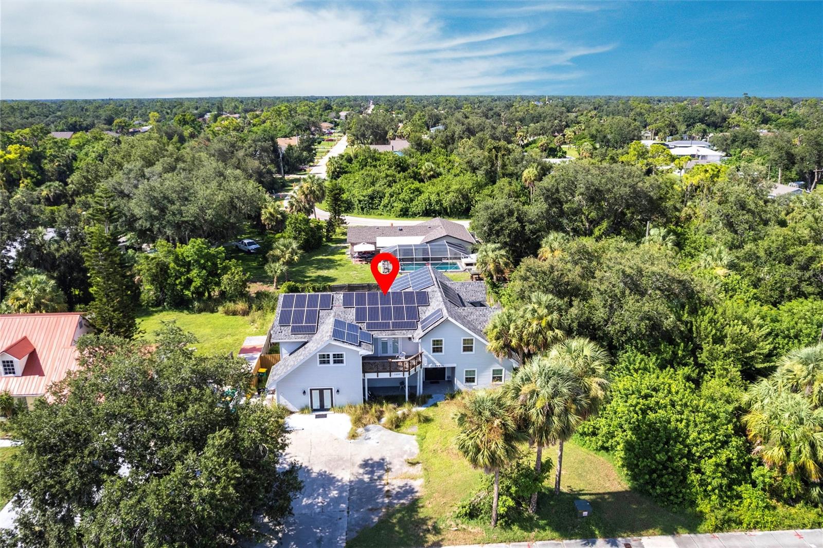 Spacious Two-Story Home with Endless Possibilities! This large, versatile home offers incredible space and flexibility to suit a variety of needs with 6 bedrooms and 6 bathrooms. Whether you're looking for room to accommodate a large family, multi-generational living, or even a group home setup, this property has it all. The home features a private in-law suite with its own entrance, cozy living area, bedroom space, private bathroom and a convenient kitchenette—perfect for guests, extended family, or rental potential. Enter into a welcoming foyer that flows into a spacious open-concept floor plan. The spacious and light-filled kitchen is the heart of the home, featuring modern updates and timeless finishes. Crisp white shaker cabinets pair beautifully with sleek gray-and-white granite countertops, offering both style and durability. The expansive center island provides plenty of prep space and casual seating, perfect for gatherings or quick meals. Enjoy the convenience of stainless-steel appliances, including a built-in microwave, dishwasher, and a double-door refrigerator. A striking black gooseneck faucet and deep undermount sink add a contemporary touch, while recessed lighting keeps the space bright and welcoming. The open layout flows seamlessly into adjoining living areas, making this kitchen ideal for both daily living and entertaining. Durable wood-look flooring ties the space together with warmth and character. The first floor includes two generously sized bedrooms, each with their own private, updated bathrooms featuring walk-in showers. The second floor features an open balcony that overlooks the spacious living and dining areas below, adding an airy, connected feel to the home’s layout. The primary suite is a true retreat, offering a huge walk-in closet, access to a private balcony, and a luxuriously updated spa-inspired bathroom featuring a striking open-concept, wet room-style walk-in shower. The shower showcases a bold and modern design with floor-to-ceiling marble-look tile, a rainfall showerhead, and a sleek black hexagon tile floor for contrast and texture. Next to the shower, a freestanding soaking tub sits beneath a sunlit window, creating a serene space to unwind and relax. Also, upstairs are three additional bedrooms, each with direct access to a balcony, along with two more full bathrooms, providing comfort and convenience for family or guests. Enjoy year-round outdoor living with a screened-in lanai that overlooks a large, privacy-fenced backyard, ideal for entertaining, play, or pets. The home also features a spacious utility room with laundry and storage, residential solar panels installed in 2022 for energy efficiency, a new A/C system with updated ductwork from 2019, and a new roof installed in 2021. Don't miss this unique opportunity—schedule your showing today and explore the many possibilities this exceptional property has to offer!
**PLEASE ENJOY THE 3D INTERACTIVE VIRTUAL TOUR ASSOCIATED WITH THIS LISTING**