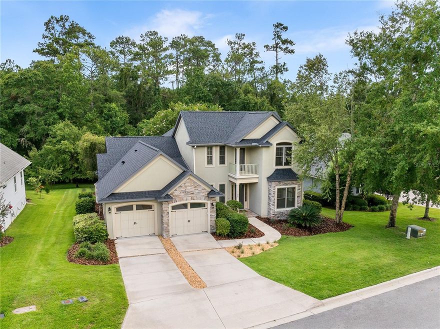 One or more photos are virtually staged. You've found a deal in this beautiful, traditional two story home built in 2008 in NW Gainesville's Ridgemont neighborhood. With 4 bedrooms plus office, 3.5 bathrooms this home offers modern amenities, peace and quiet and A-rated schools. Zoned for Hidden Oak Elementary, Fort Clark Middle and Buchholz High Schools. Ridgemont is 25 minutes to the University of Florida, 3 miles to I-75 and central to area shops and restaurants. Priced well below the area average, this 3,057 heated and cooled square foot home is ready for you. Updates include new 30 year architectural shingle roof in May 2025, new hybrid heat pump water heater in 2023, new upstairs HVAC 2019, new GE stainless steel appliances, new interior paint, new tile in laundry room and new carpet in primary suite. Off the covered front porch, you enter the double height foyer with half bathroom to your left and office to your right. The office has a wood beamed ceiling and a charming window bench. To the left of the office is the formal dining room with coffered ceiling and French doors. This could be a study, TV room or second office too. Straight ahead is the Great Room with built-in book cases, fireplace and open floor plan to the kitchen and breakfast nook or dining area. All the downstairs common areas have maple wood floors, crown molding and high ceilings. The kitchen is the star here with granite counter tops, center island with wine storage, 42 inch custom wood cabinets, gas cook top, built-in oven, microwave and pantry. The breakfast nook has a bank of windows overlooking the rear yard with beautiful views of the morning sun. Off the Great Room is a covered porch with outdoor TV and low maintenance landscaping. Enjoy the views of the woods from your open patio, perfect for entertaining friends or dining alfresco. Back inside, you will love the huge primary suite located on the first floor. There are two walk-in closets, a large bathroom suite with double vanity, tub, separate shower and private water closet. Also downstairs is the laundry room with washer and dryer, custom cabinets, laundry tub and lots of storage. Upstairs are three bedrooms, two full bathrooms, a balcony off the front of the home. The upstairs common area has maple floors and the bedrooms have bamboo flooring, no carpet. The home has custom window treatments, double paned windows and is filled with natural light throughout. The property is .40 of an acre and has an irrigation system. There is two car, attached garage. The low home owners association dues are $475 a year.