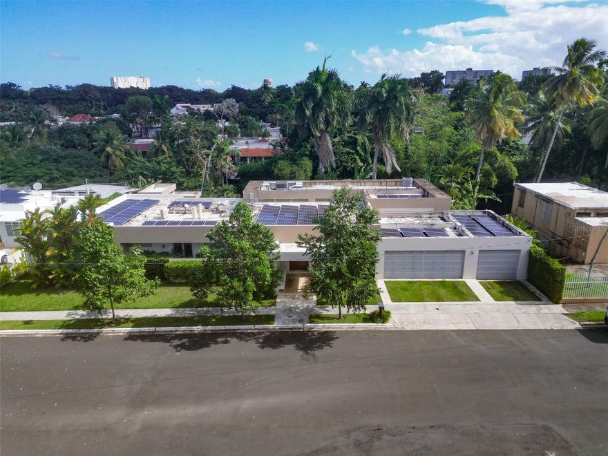 This stunning one-level contemporary residence offers 4 bedrooms, 3.5 bathrooms, 4,646 sq ft of refined interior living space, and a 1,608 sq ft lot designed for luxury and comfort. Flooded with natural light and featuring expansive open-concept areas, the home seamlessly integrates with its resort-style outdoor spaces, including a beautifully designed pool, terrace, and outdoor kitchen. The property is delivered fully equipped with an 80-panel solar system with four Tesla batteries, a full Control4 smart-home automation and A/V ecosystem, whole-house audio, six televisions, central A/C in the main living areas, and five Fujitsu split units throughout. The kitchen showcases Sub-Zero and Wolf appliances, an oversized island, and premium finishes. Additional features include a Monogram beverage center by the pool, washer and dryer, cistern, solar water heater, pool heater. A rare turnkey luxury offering in one of San Juan’s most desirable communities.