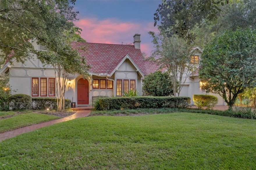 Step into storybook charm in the heart of one of Orlando’s most sought-after neighborhoods. Built in 1925, this Tudor-style gem exudes timeless character and warmth at every turn. From the moment you pull up on the brick-lined street, the curb appeal captivates, and the rounded front door with its classic mailbox slip hints at the enchanting details waiting inside. Inside, you're greeted by original wood floors, soaring ceilings with exposed beams, and a cozy wood-burning fireplace in the living room, complete with a built-in bench by the window—pure charm. Adjacent to the living room is the spacious formal dining room, featuring French doors leading to the family room, and another door providing access to the heart of the home: the kitchen. Renovated in the early 2000s, the kitchen boasts a center island, dual sinks—one overlooking the backyard—stainless steel appliances including a Wolf range connected to natural gas, Sub-Zero refrigerator, dishwasher, and wine refrigerator. The study/den leads to a hallway featuring a full bath and two generously sized bedrooms, including one with an updated en-suite bathroom. On the other side of the house, the family room is filled with natural light, showcases built-ins, and connects to the fourth bedroom with en-suite half bath and laundry, as well as stairs to the primary wing. Upstairs, the primary suite is a retreat of its own. To the right, a spacious bedroom with abundant storage and character; to the left, a large bath and an oversized walk-in closet. Step outside to a courtyard ideal for al fresco dining, a sparkling saltwater pool, private trees, and low-maintenance artificial turf. The detached in-law suite is a standout—400 sf with a private entrance, kitchenette, and full bath. Currently used as a music studio, it’s ready to be a guest suite, private office, or rental opportunity. Additional highlights include two walkable attics, plantation shutters throughout, an attached two-car garage, and a prime location just minutes from Downtown Orlando, College Park, the new Packing District, Lake Highland Prep, The First Academy, Bishop Moore High, the Creative Village, the Dr. Phillips Performing Arts Center, and easy access to I-4 and SR 408. Call today to experience this home in person!