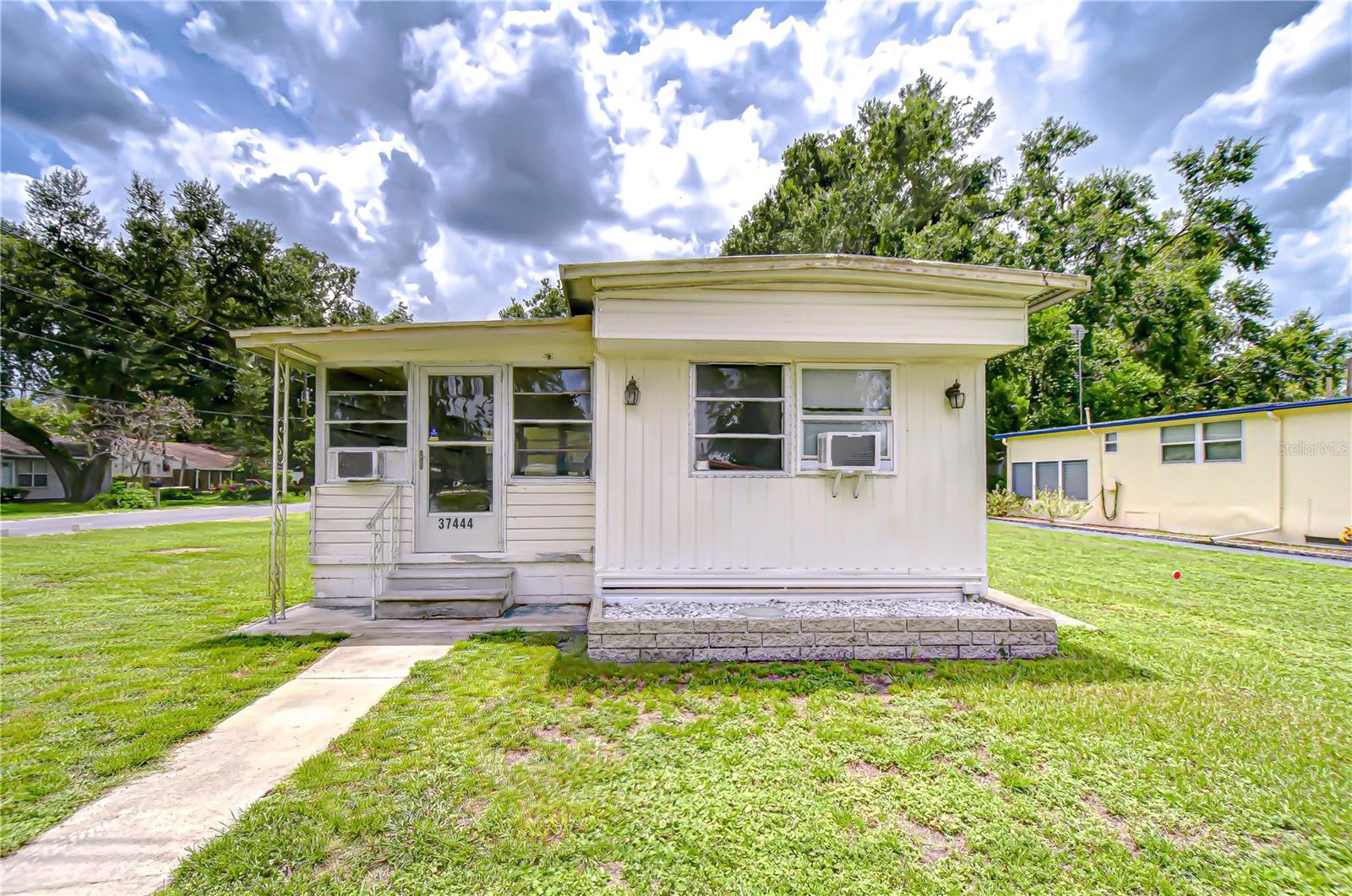 Beautifully remodeled home in senior park where you own the land. This charming single wide with addition is located in a desirable 55+ community, where one resident must be 55+ and others over 18. Featuring 2 bedrooms and 1 bathroom. This home sits on a spacious corner lot and offers comfort, style, and convenience. The primary bedroom comes furnished with built ins for extra storage. Enjoy the enclosed front family room with air conditioning and windows all around. Perfect for relaxing while feeling connected to the outdoors. Home is furnished and waiting for you. Brand new washer and dryer in the laundry area. Stove has also been replaced. Don't let this one get away. Call now for an appointment.