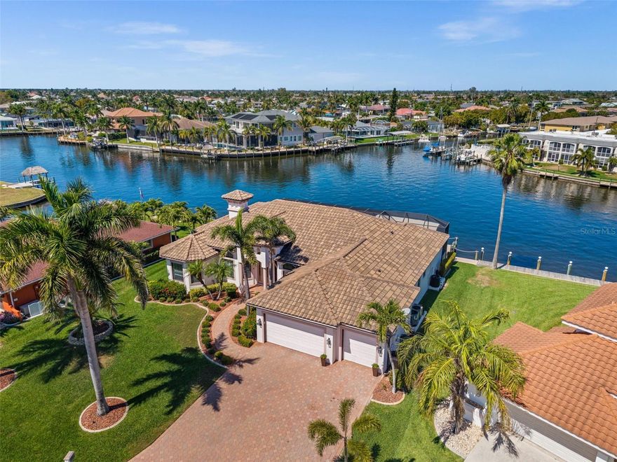 LUXURY GULF ACCESS LIVING IN THE HEART OF CAPE CORAL’S HOTTEST BOATING LOCATION! Welcome to 5205 Tamiami Ct, a beautifully maintained 3 bedroom + office, 3 bath DIRECT SAILBOAT GULF ACCESS waterfront home with 2,781 square feet on the famous Bimini Canal. This is not just a Gulf access property, it's a front-row seat to one of the most exciting waterfront areas in Cape Coral. Set on a 200 FOOT WIDE INTERSECTING CANAL BASIN with no bridges, this home enjoys spectacular views, quick access to open water in about 8 minutes, and a location that is becoming more vibrant by the day. With Bimini Square now open just minutes away by boat, the energy on the water here is incredible. Boats are constantly cruising by on their way to and from the restaurants, day slips, and waterfront activity at Bimini Basin, and the adjacent 25-acre retail and commercial development is set to bring even more excitement to the area. Add in walkability to downtown Cape Coral and quick access to the Cape Coral Bridge, and it is hard to imagine a better place to enjoy the Southwest Florida lifestyle. Inside, the home was designed to showcase the water from the moment you walk in. The spacious open layout, soaring ceilings, and large windows and sliders keep the focus on the stunning basin views. The kitchen has been updated, and recent upgrades also include the roof, flooring, two air conditioners, pool equipment, lanai cage, and outdoor lanai fridge and freezer. The split-bedroom floor plan offers 3 full baths, a dedicated office, and generous storage throughout. Step outside and the lifestyle comes alive. The oversized picture-window screened lanai features an outdoor kitchen, heated saltwater infinity pool, and spa, all perfectly positioned to overlook the wide canal intersection. Whether you are entertaining friends, watching the boats pass by, heading out for dinner by water, or relaxing at home in one of Cape Coral’s best spots for the Christmas boat parade, this property delivers the kind of boating lifestyle people dream about.