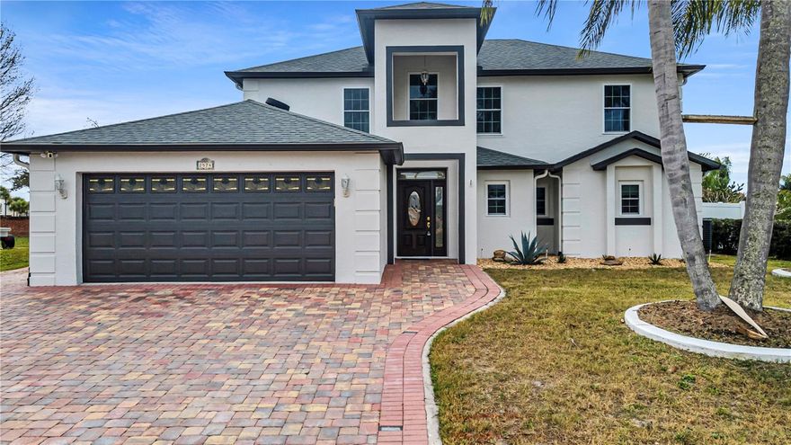 Beautifully maintained 4-bedroom, 2.5-bath home with NO HOA, offering custom features and move-in-ready comfort. Highlights include a striking paver driveway with accent lighting, a low-maintenance backyard, and a fully enclosed sunroom with A/C for year-round enjoyment.

The open living and dining area features soaring 18-foot ceilings, creating a bright and spacious feel. The eat-in kitchen offers Silestone countertops, ample storage, and a movable island. Primary suite on the first floor includes a spa-style bath with custom tile, whirlpool tub, and separate shower.

Additional features include a climate-controlled workshop, generous storage including attic space, and flexible upstairs bedrooms. Major updates include a 2017 roof, A/C replaced in 2021, gas heater (2024), and double-pane impact windows.

Conveniently located with easy access to Central Florida attractions. A rare opportunity with no HOA—schedule your showing today.