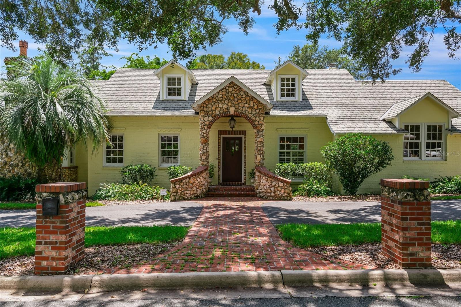 Welcome to Golfview Estates! This meticulously cared-for home offers 3 or 4 bedrooms, 2.5 bathrooms with over 4,136 sq. ft. of living space with a screened, solar-heated pool and hot tub overlooking the 9th green. Step inside to the original hardwood foyer with a staircase leading upstairs. To the right, a formal dining room features original hardwood flooring and crown molding. The formal living room also showcases hardwood floors, a gas fireplace and backyard views. The kitchen has North Carolina heart pine floors, granite countertops, a breakfast bar, and stainless-steel appliances, including a Viking gas range, Bosch dishwasher, KitchenAid side-by-side refrigerator and wine fridge. The kitchen opens to an eat-in area, sitting room and screened back porch—perfect for entertaining or enjoying morning coffee with golf course views. A hallway lined with built-in cabinetry leads to a spacious den/office, powder room and the primary suite. The primary bedroom features a cathedral wood paneled ceiling, gas fireplace, expansive walk-in closet with custom built-ins and direct access to the pool. The ensuite bathroom offers dual sinks, soaking tub and a walk-in shower. Laundry is conveniently located within the suite. Upstairs, find two additional bedrooms plus a converted attic space ideal for a third bedroom, reading nook or flex space. The upstairs hall bath features a clawfoot tub and separate walk-in shower. Two staircases provide easy access to the second floor. Enjoy outdoor living with your screened solar-heated pool and hot tub, covered porch and a brick courtyard between the home and detached two-car garage—perfect for gatherings and afternoon relaxation. Mature landscaping surrounds the home. Additional features: three-zone A/C, abundant storage and thoughtfully designed living spaces. This rare find in Golfview Estates blends craftsmanship with modern comforts—all with unbeatable golf course views. Walk to Ben Hill Griffin Football Stadium. Easy access to UF, UF Shands, HCA Healthcare, local restaurants and shopping.