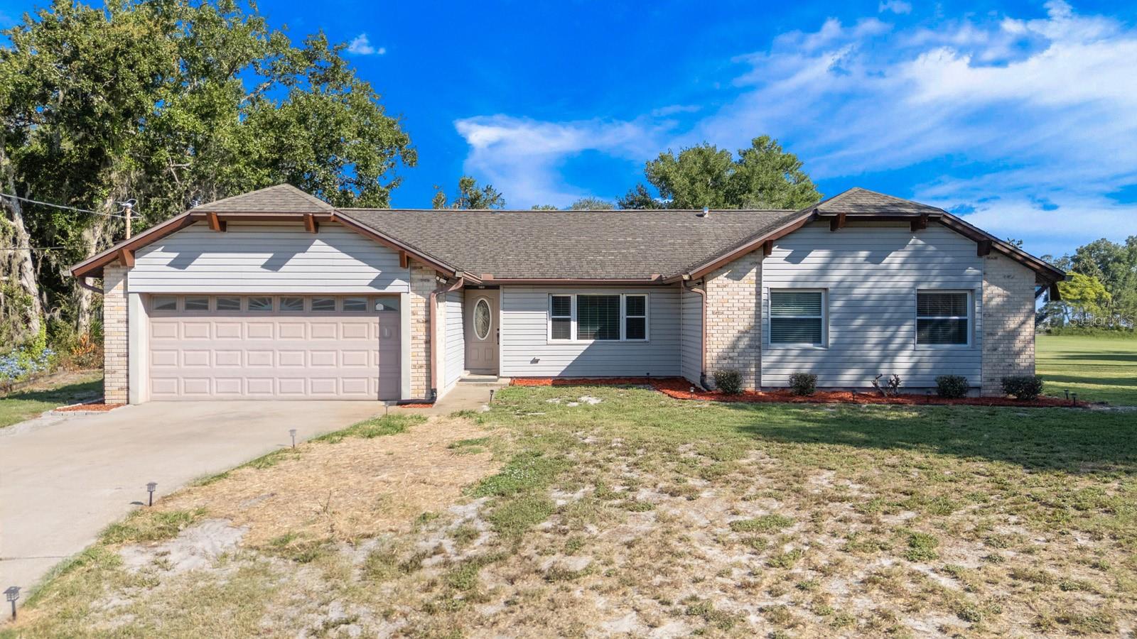 Welcome to your HGTV dream come true! This beautifully updated 3-bedroom, 2-bathroom home offers over 1,500 square feet of living space on a sprawling half-acre lot, tucked away in a quiet cul-de-sac with NO HOA! BONUS! BRAND NEW MAIN ROOF with acceptable offer! You even get to pick the color! WOW! Step inside and be greeted by soaring cathedral ceilings, fresh interior paint, and gorgeous new laminate flooring that flows seamlessly through all living areas and bedrooms. The open-concept layout is perfect for entertaining, with a chef-inspired kitchen featuring sleek gray cabinetry, granite-look countertops, a newer microwave (2024), brand-new dishwasher (2025), and stainless-steel refrigerator.
The spacious family room boasts French doors that lead to your private outdoor oasis, while the separate dining room also features elegant French doors and a brand-new LED light fixture with a convenient nightlight mode.
Down the freshly painted hallway, you’ll find the expansive primary suite with floor-to-ceiling windows, BRAND NEW flooring, and a wall-length closet. The en suite bathroom has been tastefully updated with modern vanity, toilet, lighting, and fixtures, fit for royalty!
Both guest bedrooms are generously sized with ceiling fans and fresh paint, and the guest bath has been updated with a newer toilet and a clean, refreshed look. Additional highlights include: WiFi-enabled garage door motor with new rollers and chain and an electrical panel with whole-home surge protector, peace of mind during Florida’s wild weather. Step outside and onto your massive Florida room perfect for relaxing evenings, weekend gatherings, a playroom, hobby studio, or even an outdoor-style dining area. Let your imagination run wild! Oh and did I mention, two spacious metal sheds for all your toys and goodies. All of this on over half an acre of outdoor space and no HOA restrictions, you’ll have room for gardening, a playground, or even a future POOL! WOW! Conveniently located LESS THAN 3 MILES FROM I-4, you are only minutes from shopping, restaurants and access to Orlando International Airport, Disney World and Daytona’s ‘World Famous’ beach! Come see this majestic home before it is too late! Schedule your exclusive tour, TODAY!