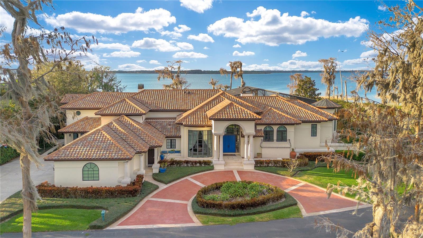 Experience waterfront living in this one-of-a-kind lakefront home. Nestled on a secluded peninsula with DUAL deeded lake access on the coveted Butler Chain of Lakes. This stunning property features TWO private boat DOCKS, one for Lake Sheen and one for Lake Tibet an exceedingly rare amenity in FL. This meticulously designed estate is more than a home, it’s a lifestyle. Showcasing flawless craftsmanship, blending Mediterranean elegance with modern sophistication. Offering an open and airy floor plan designed to capture breathtaking water views from every room. The grand living room with soaring ceilings, striking fireplace, climate-controlled wine cellar with wrought iron door is perfect for the avid wine collector. The formal dining room displays floor-to-ceiling windows, allowing stunning lake views and natural light to fill the space, creating an ambiance for intimate dinners. At the heart of this home is the remodeled chef’s kitchen, that’s sure to impress. Equipped for entertaining on any scale, featuring luxurious quartz countertops, Sub-Zero appliances, six-burner Wolf range with grill and dual convection oven, Sub-Zero wine chiller, butler’s pantry with sink is a hidden gem for extra storage and prep space, custom cabinetry, storage for all your kitchen essentials, Ice maker, large island with ample seating, a stylish profile vent hood is the focal point. Casual dining area is ideal for everyday meals. The generous size family room off kitchen offers a warm and inviting atmosphere with a picturesque scenery, featuring tall detailed ceilings with custom woodwork and a stately fireplace. Oversized windows showcase captivating lake views. The primary suite presents a stone fireplace, cove ceiling with lighting and an oversized sitting area, perfect for a workout space. Step onto the private terrace to enjoy impressive sunsets and lake views. The dual spa-like remodeled bathrooms feature a walk-in shower, a two-person air-jetted soaking tub, separate water closets, and custom walk-in closets. Adjacent to the primary suite is an oversized private office. Upstairs features two spacious guest ensuites, a workstation and bonus room adding generous accommodation. Game room with adjoining Recreational room located off the family room provides versatility, creating an ideal entertainment hub. The screened enclosed pool area offers ample space for lounging, entertaining and swimming. The cabana with renovated full bath and kitchenette, is perfect for hosting poolside gatherings. The outdoor oasis incorporates mature foliage and several side conversation areas. The two deeded private ## docks are perfect for the water enthusiast, a very rare find. Launch your boat, jet ski or paddle board for fun-filled days on the lake. Enjoy Disney fireworks and Space Coast launches right from your docks. Other upgraded features include a whole-yard mosquito misting system, whole house generators, climate controlled basement, 4K Security surveillance, Tesla Car charger. Guard gated community. Conveniently located near A-rated schools, Dr. Phillips Community Parks, with outdoor amenities. Just minutes from newly designed O-Town West, Disney Springs, "Restaurant Row," Dr. Phillips Marketplace, Medical, Bay Hill, Shopping, Dining, Premium Outlets, SeaWorld, Universal Studios, and All Disney attractions. Easy access to I-4, and major roadways. This home is your gateway to lakeside living and adventure. Schedule your private tour today!