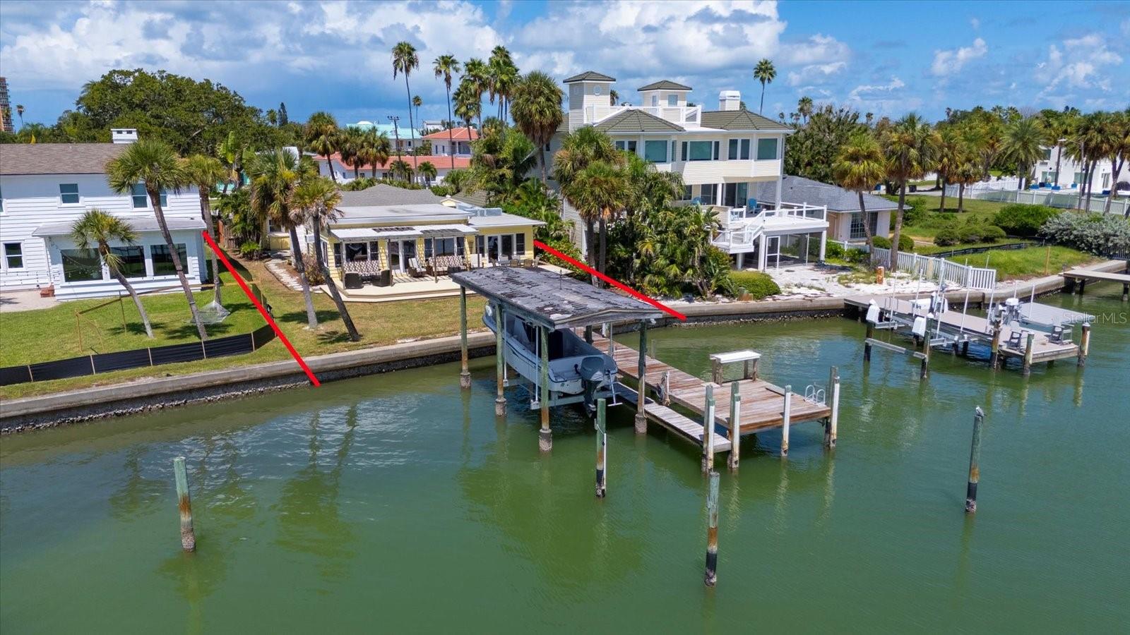 Discover the rare opportunity to design and build your own coastal retreat on this residential lot with 60 feet of bay frontage. Wake each morning to breathtaking sunrises over the water, with dolphins and manatees often playing at the end of your covered boat dock and a wide variety of water birds to admire. Enjoy fishing, tubing, and skiing right from your backyard, with easy accessibility to the Intracoastal Waterway, just five minutes away. Spend the days exploring the coastline or relaxing and admiring your view.
This North Clearwater Beach location offers the best of both worlds: just moments from the lively stretch of Mandalay Avenue where you'll find the bustling Pier 60 with its entertainment and attractions, dining and luxury hotels. — or take a short, peaceful stroll to the quiet, residential beach access where you’ll find virtually secluded stretches of soft white sand and unforgettable sunsets, without a neon sign in sight!
For the water lover, it’s all here: a boat in the back yard and sandy shores with gentle waves just steps away. And with Tampa International Airport, luxury shopping, major sports teams, concerts, and nightlife no more than 30 minutes from home, you can live like you're on vacation, without sacrificing the energy and amenities of a thriving city.
This is the perfect canvas to build your dream home and live the ultimate Florida lifestyle.
THIS LISTING IS FOR LAND ONLY. HOUSE IS SUBSTANTIALLY DAMAGED.