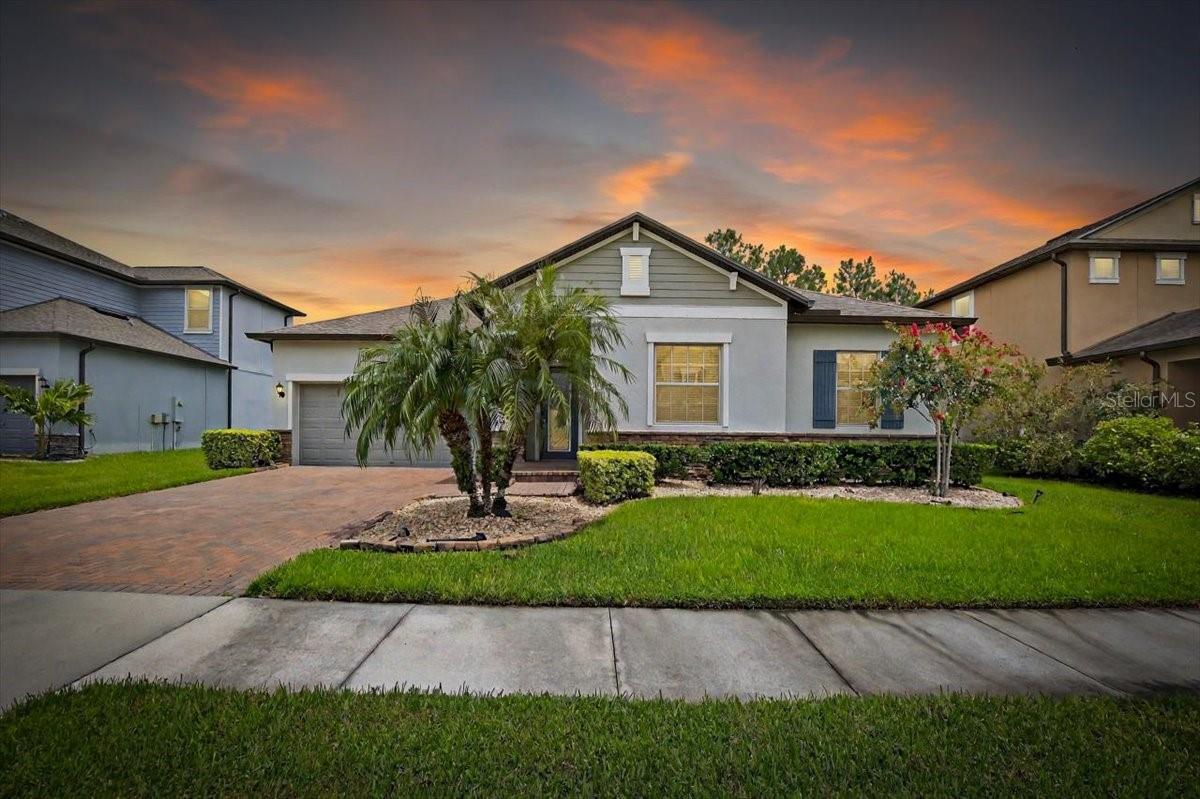 Gorgeous 4-bedroom, 2.5-bathroom house in The Enclave at Meadow Pointe, a secure gated community, This single-story gem boasts an expansive 2472 square feet and an open floor plan. The home features tile flooring in the main areas and luxury laminate flooring in the bedrooms. The kitchen, a culinary haven, boasts stainless steel appliances, granite countertops, and a spacious central island, perfect for hosting. The master suite is a retreat with a generous space, a garden tub, separate his and hers sinks, and an extensive walk-in California style closet. Step outside to a serene atmosphere with a sizable, screened patio and a fully fenced backyard. Park up to three cars in the tandem garage, which also provides ample storage space. Plus, the convenience of a washer and dryer included! Located near The Shoppes at Wiregrass Mall and just a 10-minute drive from I75, Meadow Pointe IV ensures easy access to amenities. Experience resort-style living with community pool, playground, volleyball, fitness center, and basketball courts. Don't miss out—schedule a viewing today!