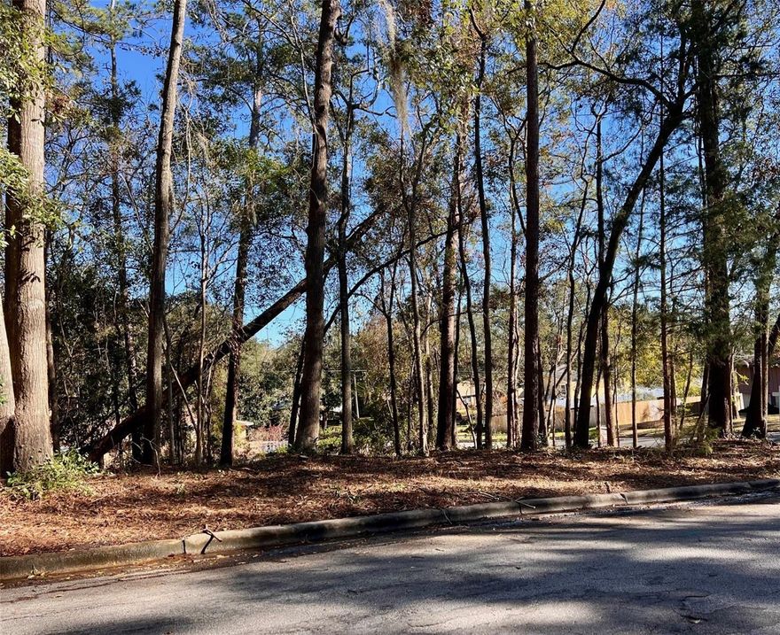 .33 acre wooded corner lot located in the well established, highly sought after Kingswood! Bring your own builder and be in the heart of NW Gainesville. Conveniently located near UF, UF Health, Westside Park and Thornebrook Village shopping and restaurants! Walk to Gainesville Health and Fitness for your workouts or Cymplify for your morning coffee. Or stay in the community and enjoy miles of sidewalks to ride your bike or walk as Kingswood connects to other similar neighborhoods like Suburban Heights. Great schools, public and private, nearby, as well as   the post office, library, parks, and more! No HOA dues saves you money.