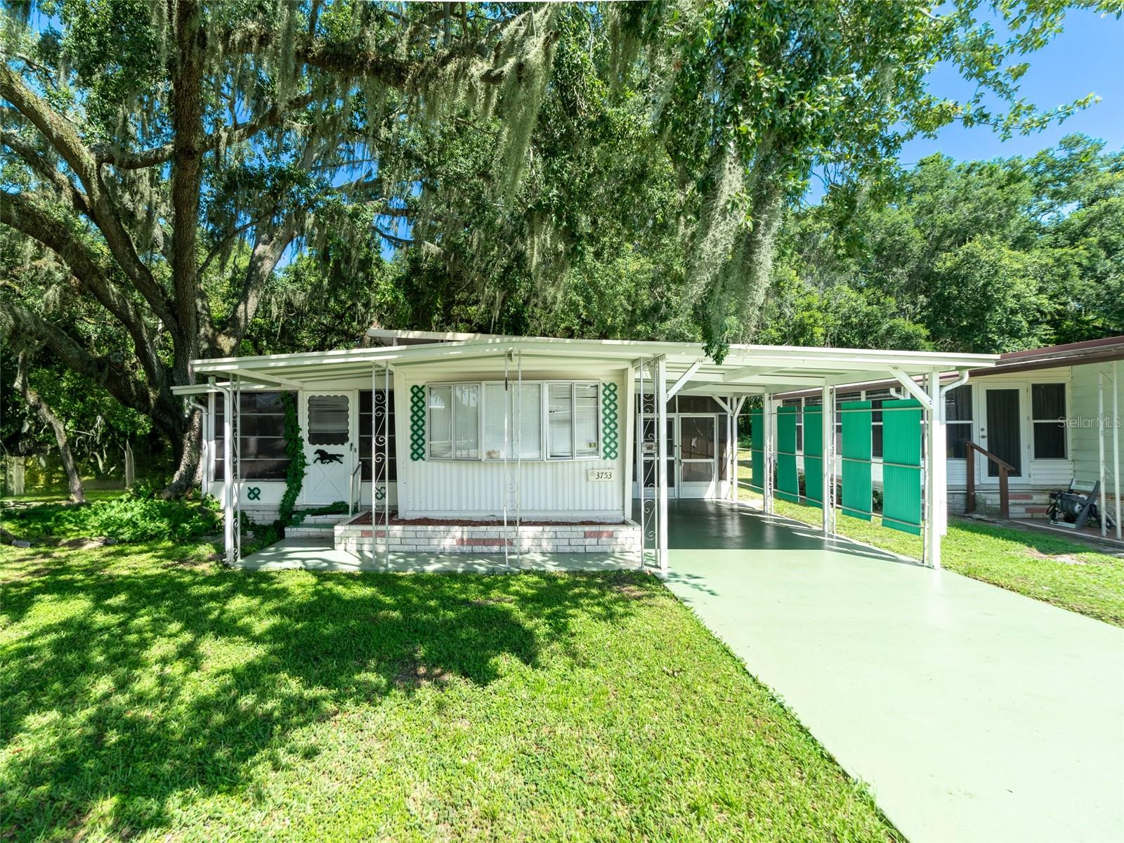 2 LOTS:Its like having your own park. 2 bedroom 2 bath on two tree shaded gorgeous lots in Shady Oaks. So much room in this home with a 15x19 living room, large kitchen pantry, front Florida room, screen porches utility storage and workshop. OWN your LAND in this established 55+ community with low HOA fees which include the community pool, shuffleboard, clubhouse, activities and events. Located just South of Zephyrhills with easy access to several highways to commute to Plant City, Orlando, Lakeland, Tampa or the Beaches in Sunny Florida!