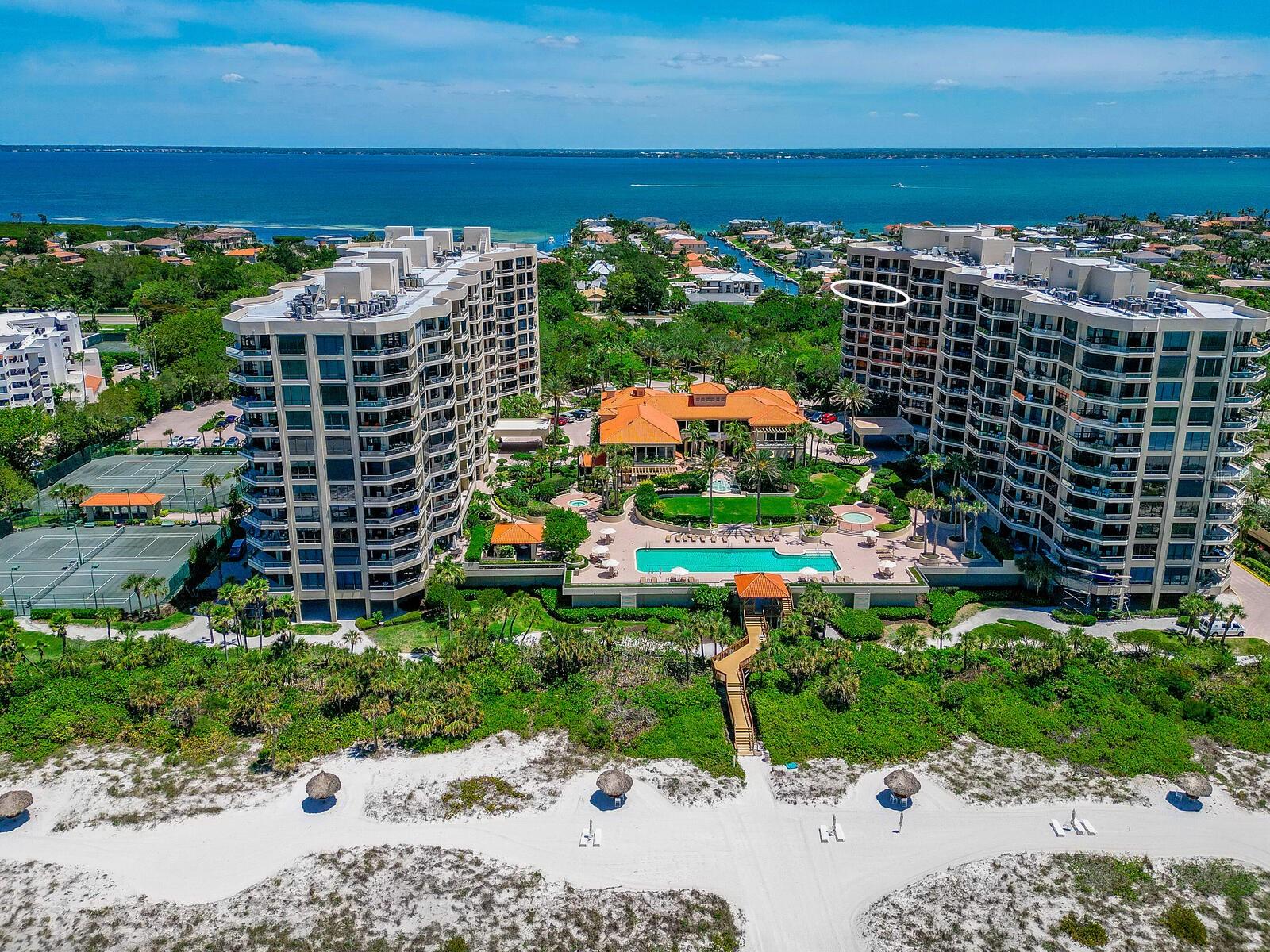 This rarely available eighth-floor condominium at the exclusive Water Club features breathtaking views from three covered terraces. The three balconies feature views of the Gulf and pristine white sand beaches along with stunning views of downtown Sarasota and turquoise water views of the Bay. Perfectly detailed, the master bedroom is a haven of serenity with sliding glass doors that open to a bay view terrace and upgraded marble tile and glass which highlight the master bath. Spacious walk-in closets afford abundant storage. A defining focal point, the dreamy white kitchen features granite countertops, picturesque views of the Bay, and a seamless connection to a casual breakfast area. The den space converts perfectly to a third bedroom with a retractable in-wall door. The Water Club offers a plethora of amenities including tennis courts, a fitness center, a junior Olympic sized pool, hot tub, climate controlled storage space, and dedicated concierge services. Located just minutes from St. Armands Circle and downtown Sarasota, this residence is only a short drive away from world class golfing, shopping, and elegant dining options.