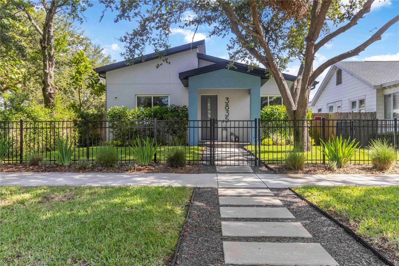Welcome to a rare opportunity in one of St. Pete’s most vibrant and connected neighborhoods. This contemporary 3-bedroom, 3-bath residence blends thoughtful design with high-end finishes across 1,691 sq ft of open-concept living. Built with quality and efficiency in mind, this block construction home features hurricane-impact PGT windows and doors, 10-foot ceilings, and wide-plank wood laminate flooring throughout.
The chef’s kitchen is a showstopper—boasting a Samsung appliance suite, Sharp microwave drawer, gas range, granite countertops, and two-tone wood cabinetry with under-cabinet lighting. A spacious island anchors the open living and dining areas, perfect for entertaining or everyday living.
Retreat to the primary suite with a spa-inspired bath featuring a 30 sq ft walk-in shower with upgraded tile and fixtures, designer porcelain finishes, and custom-built closet systems. Smart home pre-wiring, a tankless gas water heater, and energy-efficient systems ensure comfort and convenience, while the whole-home speaker system offers seamless audio throughout your living spaces.
Step outside to a covered and screened entertaining patio with recessed lighting, fan, tv hook up and in ceiling speaker system —ideal for relaxing or hosting. The fully fenced yard is beautifully landscaped with native Florida foliage and irrigated by a private well.
A detached 2-car garage offers generous storage and workshop space, PLUS a 530 sq ft upstairs flex suite with a full bath—perfect for guests, a home office, or rental potential.
Located minutes from downtown St. Pete and the Gulf beaches, with easy access to the SunRunner transit line, this home offers the best of Florida living in a dynamic, walkable community. Call the listing agent today for your VIP tour!