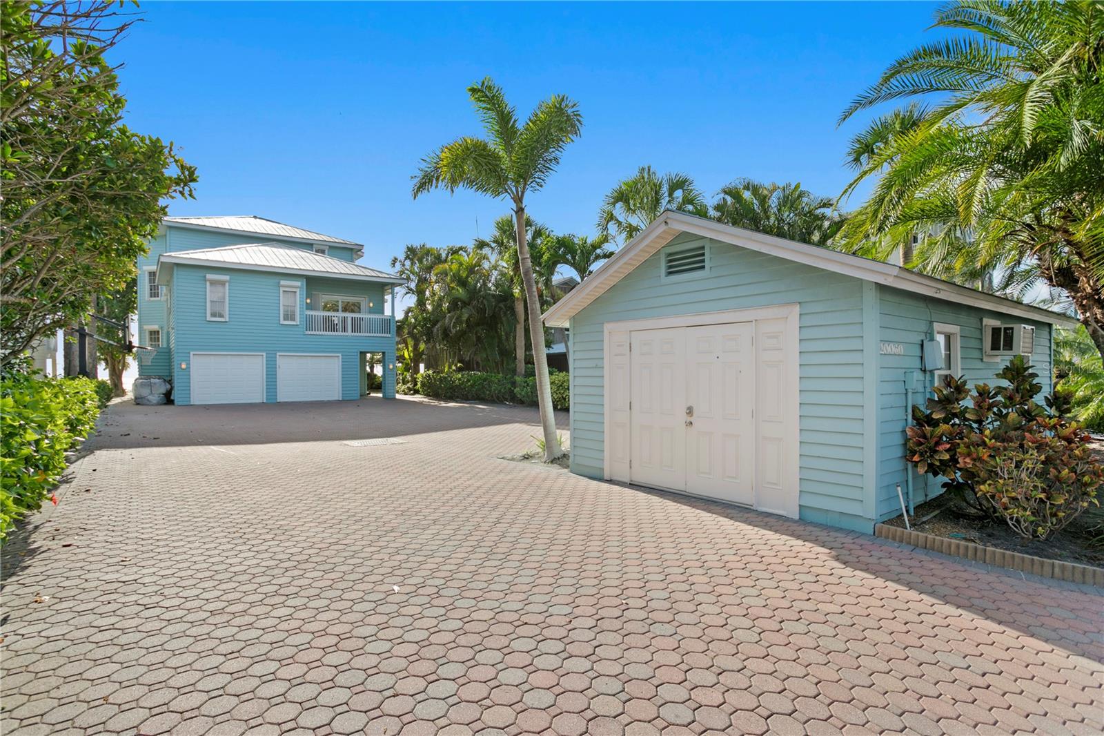 Welcome to your own private sanctuary on Indian Shores—an exclusive waterfront estate that blends timeless architecture, elevated comfort, and unrivaled Gulf-to-Intracoastal access. This one-of-a-kind property spans both sides of Gulf Boulevard, offering direct beach frontage on the west and private boat access on the east. The eastern parcel features a private, covered dock ideal for boating enthusiasts. Buffered by discreet commercial land, this area offers additional potential for creative expansion, boutique business, or investment. To the west, the main residence rises gracefully above the dunes, allowing you to step directly onto the sand from your private beachfront terrace.
Privately commissioned and perfect for those with passion for refined living, the estate was thoughtfully designed for those who appreciate both sophistication and ease. Panoramic Gulf views greet you the moment you step into the elevated living areas, while rich interior finishes and a custom chef’s kitchen elevate every gathering—from vibrant entertaining to peaceful mornings with a sea breeze. The second floor offers an effortless flow: from the expansive living and dining spaces to a family room ready for game nights and two beautifully appointed bedrooms. Ascend to the third-floor master retreat—a true haven in the sky. With a spa-inspired en-suite bath, oversized walk-in wardrobe, and serene sitting area, it’s a place to unwind and watch the sunset melt into the ocean, wine glass in hand. Multiple balconies provide spectacular indoor-outdoor living, ideal for intimate mornings or hosting unforgettable beachside soirées. Below, the first level delivers function and flexibility, with an oversized garage, spacious workshop, storage suite, and additional half bath/beach bath. A detached guest house completes the estate, offering full privacy for guests or the perfect opportunity for a luxe rental, home office, or artist’s retreat. This is more than a home—it’s a once-in-a-lifetime coastal estate, crafted for those who demand the exceptional. Rarely does such a property become available on one of Florida’s most desirable and exclusive stretches of shoreline.