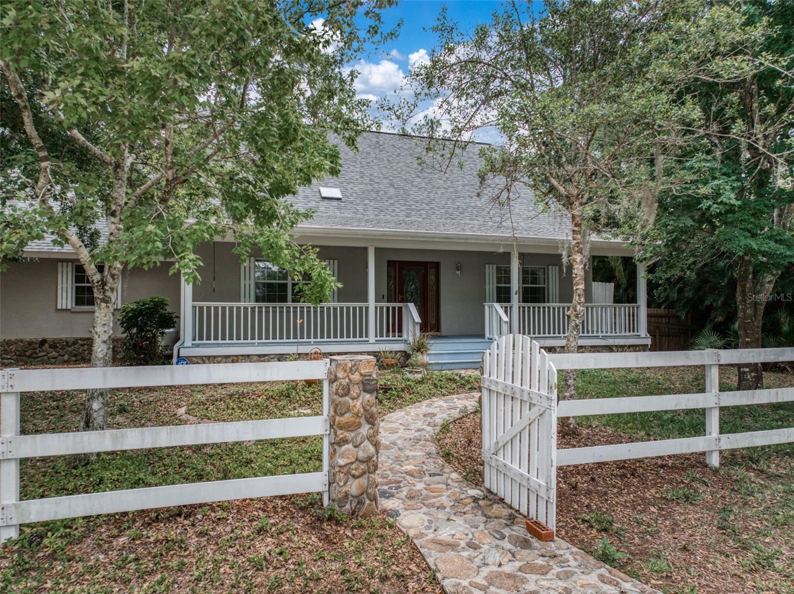 This Mountain Inspired Cabin Build is Peacefully Tucked Away on One (1) Full Acre in the Highly Sought After Orange Blossom Estates! The Charming Entryway and Inviting Front Porch Sets the Tone and Leads to a Large Open Living Area Featuring Beautiful Engineered Hardwood Floors, Soaring Tongue and Groove Ceilings Which Provides Tons of Natural Light Through Two Skylights and a Fireplace that Completes the Ambience of the Space. Staying True to the Design, the Kitchen Features Wood Cabinets Topped w/ Granite and Modern Stainless Appliances for that Country-Luxury Feel! The Floor Plan Allows for a Variety of Options and Contains Tons of Living Square Footage. The Master Bedroom and En-Suite is Downstairs, Together w/ an Additional Bedroom/Office Space and Separate Full Guest Bathroom. Upstairs is Another Full Bathroom and Bedroom Together w/ an Open Loft That Could Be Used as a Separate Living Area for that Section of the Home or Possibly Even Converted Into a 4th Bedroom. The Spacious Indoor Laundry Room Leads Into an Awesome Fully Insulated and Air-Conditioned Approximately 900 Sq. Ft. Garage Where You Can Park Your Cars, Have an Epic Man Cave, Additional Work Space or Game Room and the Loft Above the Garage Provides Even More Air Conditioned Space to Make Your Personal Design Complete!! For Peace of Mind the Roof and Loft / Garage A/C Unit Were Replaced in 2023. Also, the Garage is Currently Outfitted w/ a Unique Storm Shelter for Protecting the Ones You Love the Most. The Screened Back Porch Overlooks a Fenced Area Perfect for A Dog Run, Landscape Consisting of Native Florida Views and an Additional Smithbuilt 10x16 Shed for More Storage! Make This One Yours Today and Enjoy all the Unique Intricacies of a Cabin Build w/o the Cold Mountain Winters!